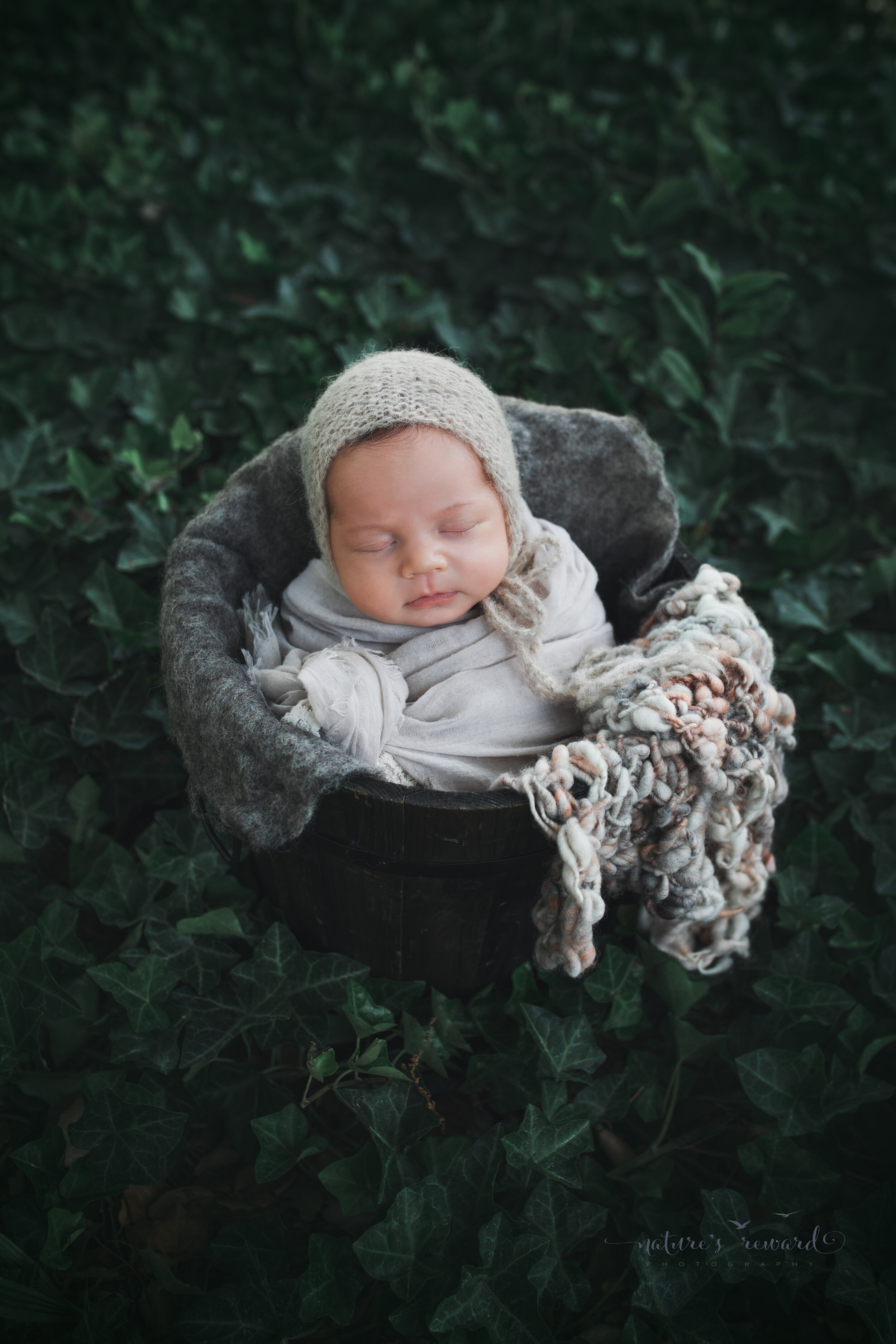 Newborn Baby girl in garden portrait by Nature’s Reward Photography