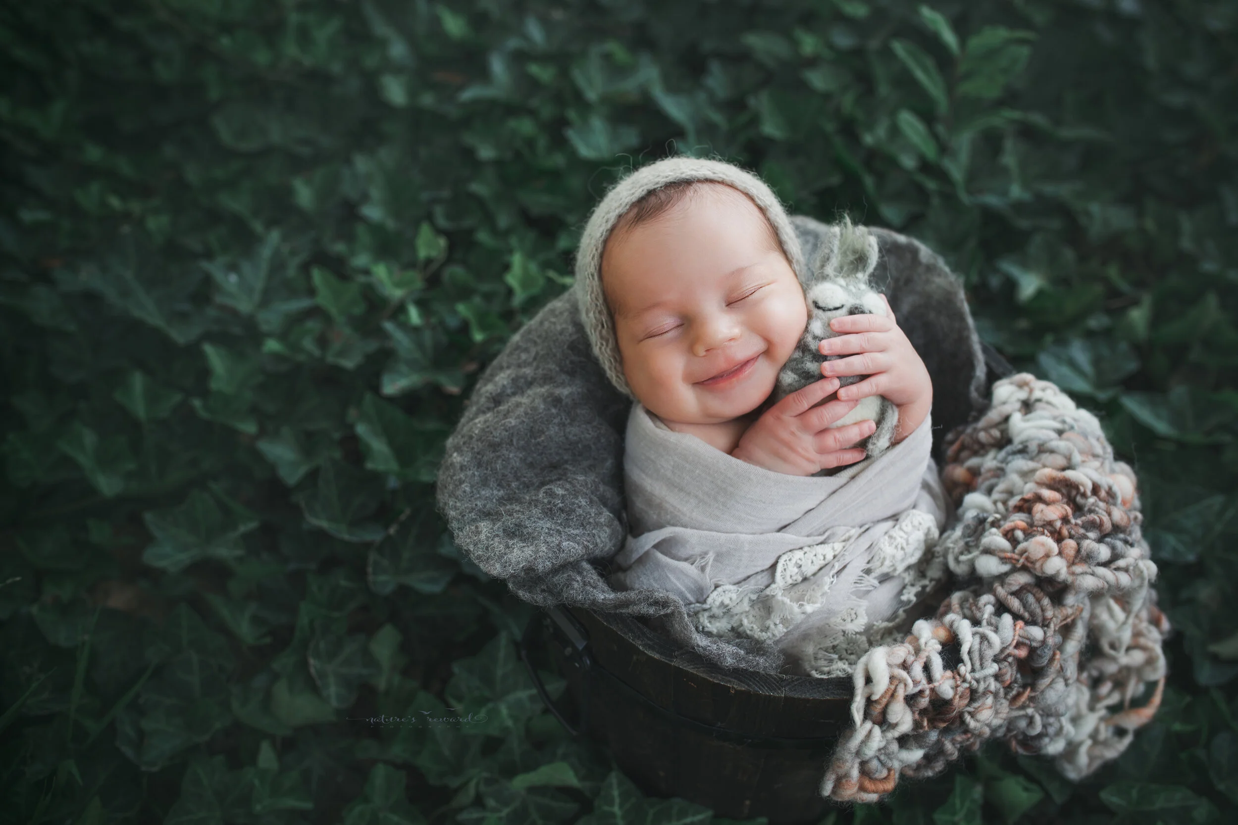 Newborn Baby girl in garden portrait by Nature’s Reward Photography