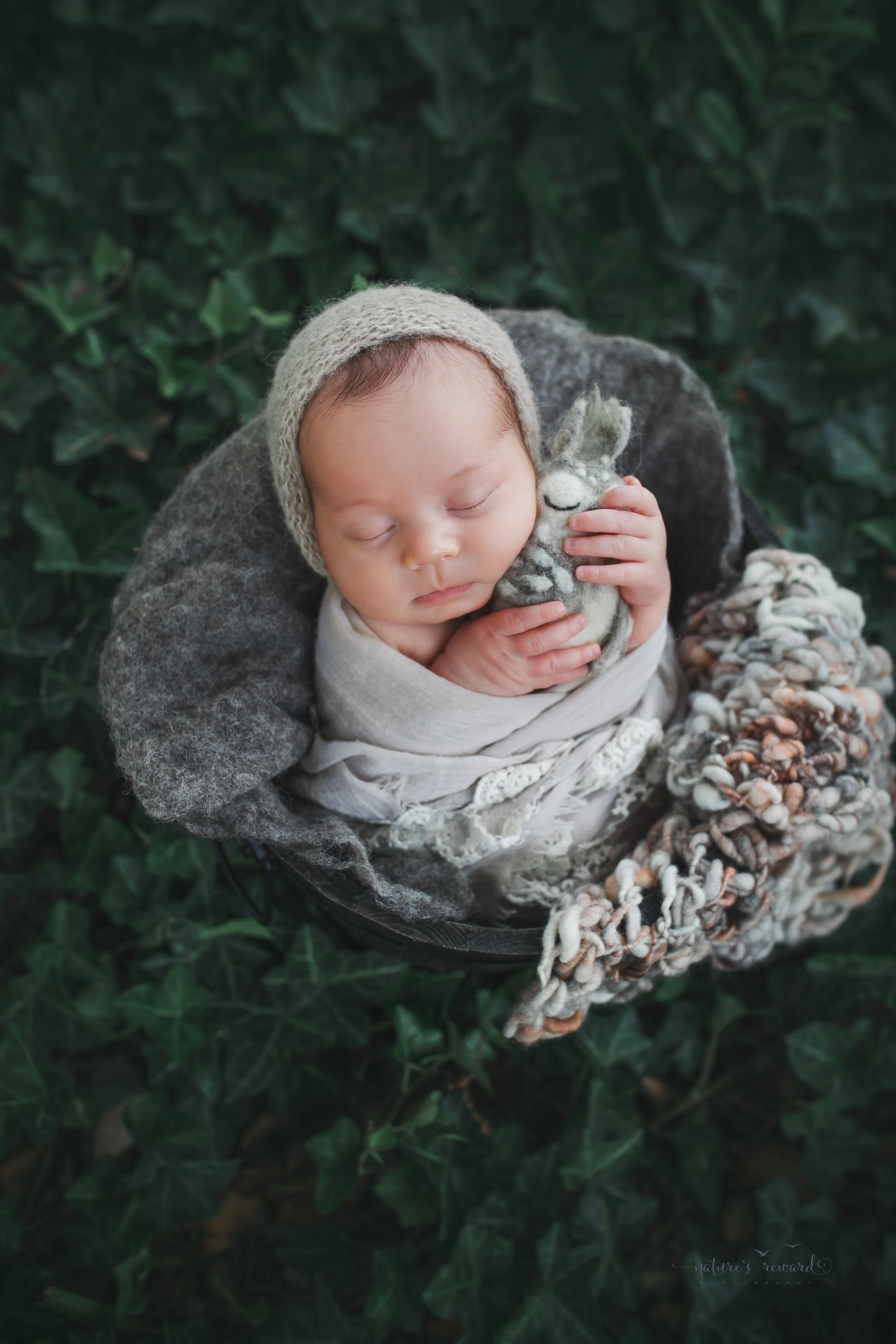 Newborn Baby girl in garden portrait by Nature’s Reward Photography