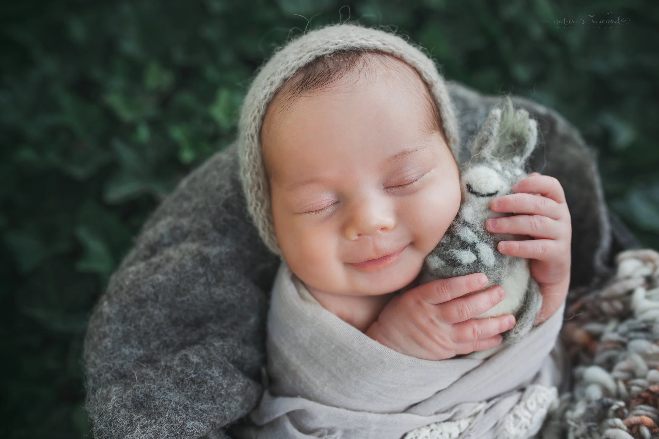 Newborn Baby girl in garden portrait by Nature’s Reward Photography