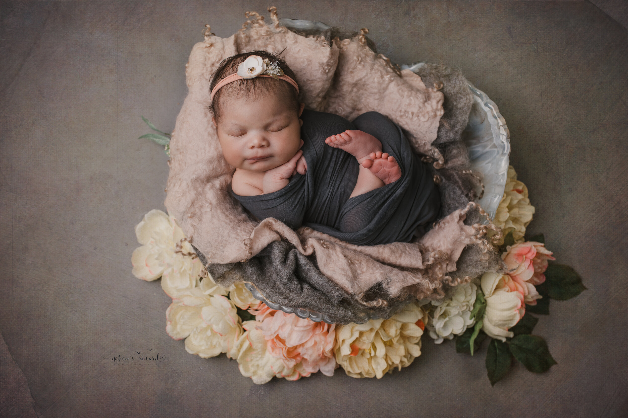 Newborn Baby girl swaddled in natural neutrals a portrait by Nature’s Reward Photography