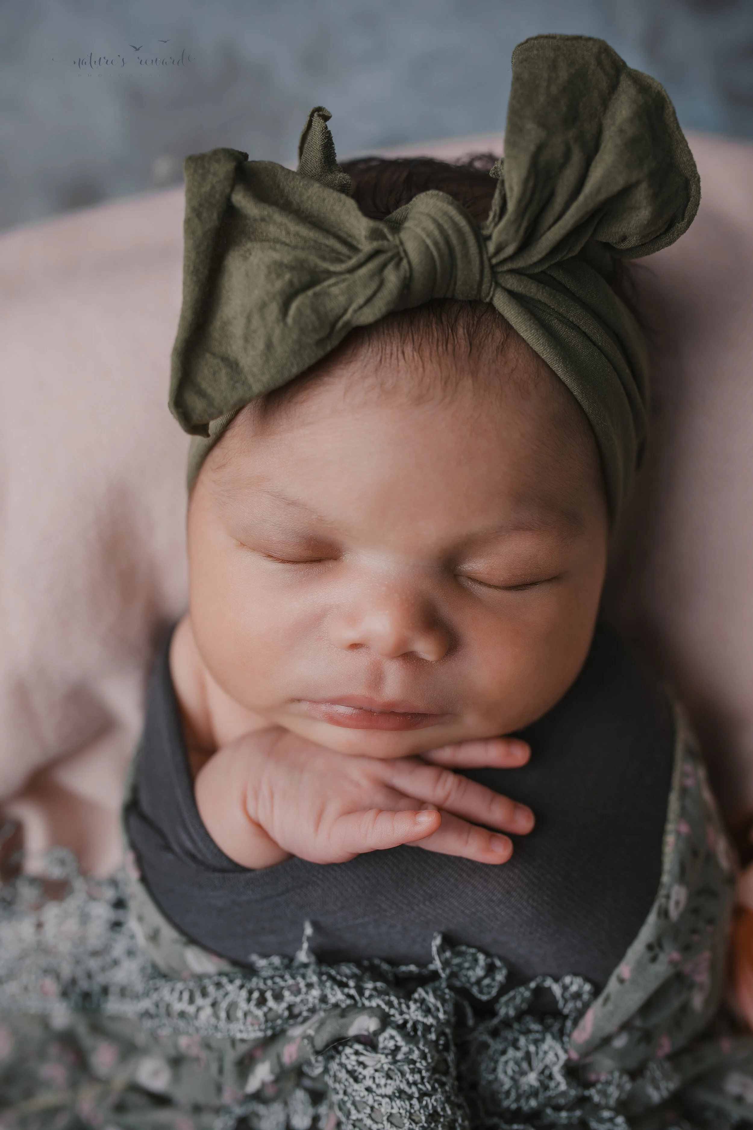 Newborn Baby girl swaddled in natural neutrals a portrait by Nature’s Reward Photography