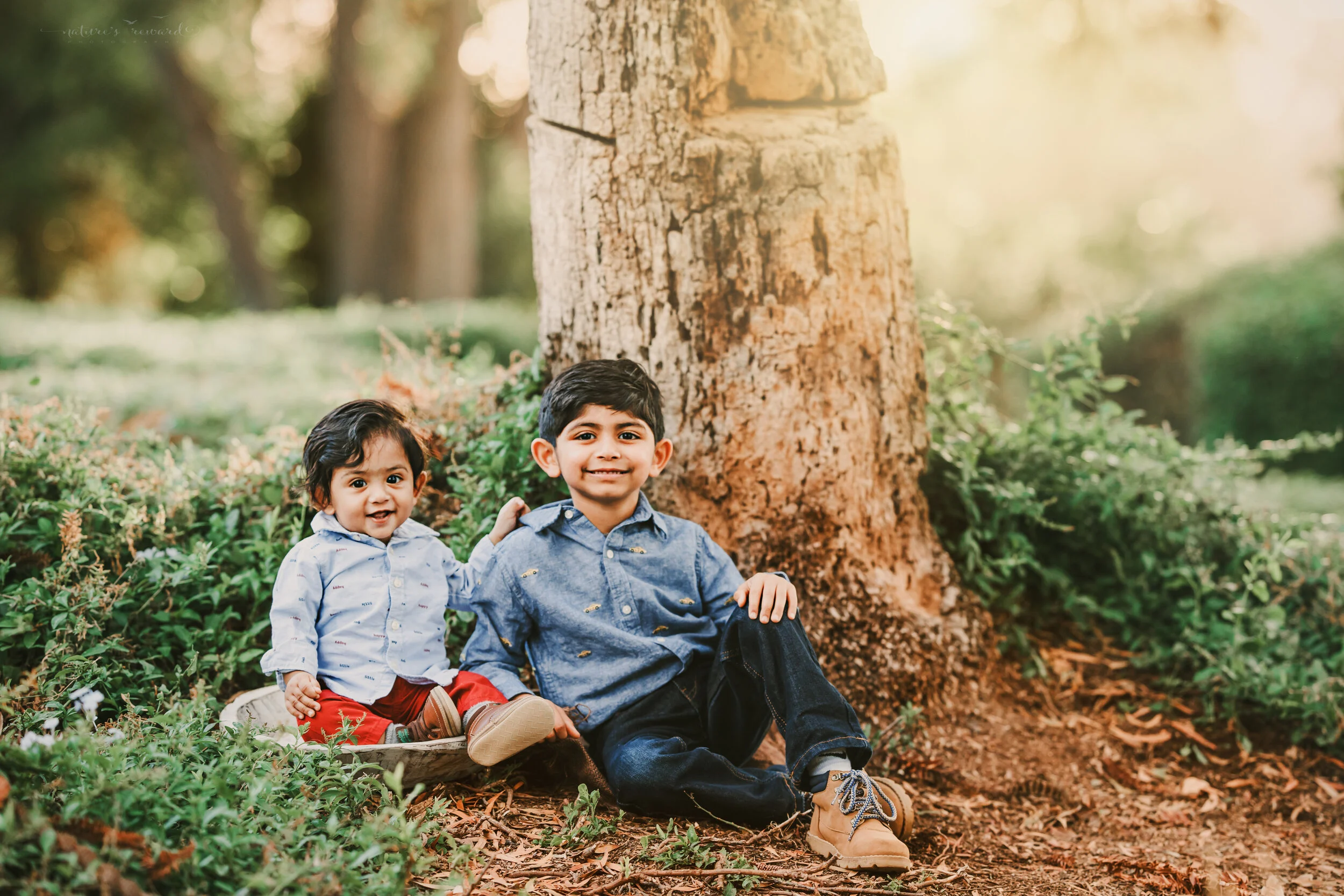 Fall sibling portrait in a lush green park in redlands California, by San Bernardino photographer, Nature’s Reward Photography.