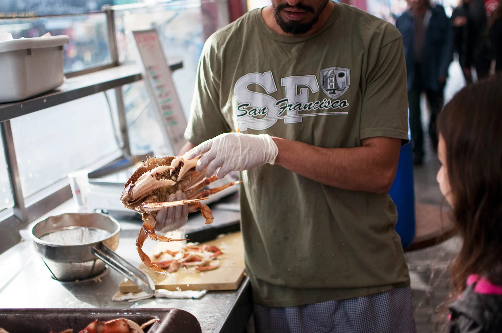 A restaurant worker shows a crab to a girl at Fisherman's Wharf on Nov. 26, 2013 in San Francisco, Calif. November is the start of crab season in the Bay Area.