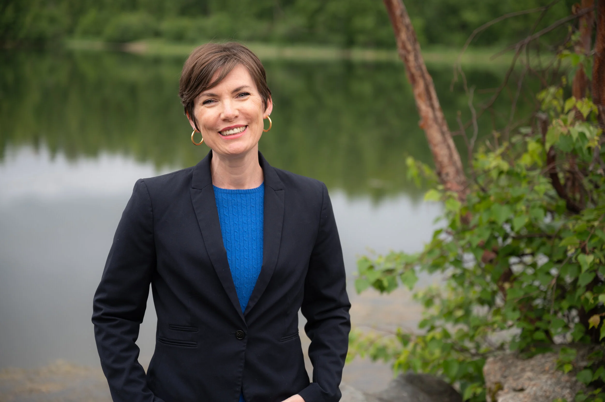Representative Ivy Spohnholz standing in front of a lake