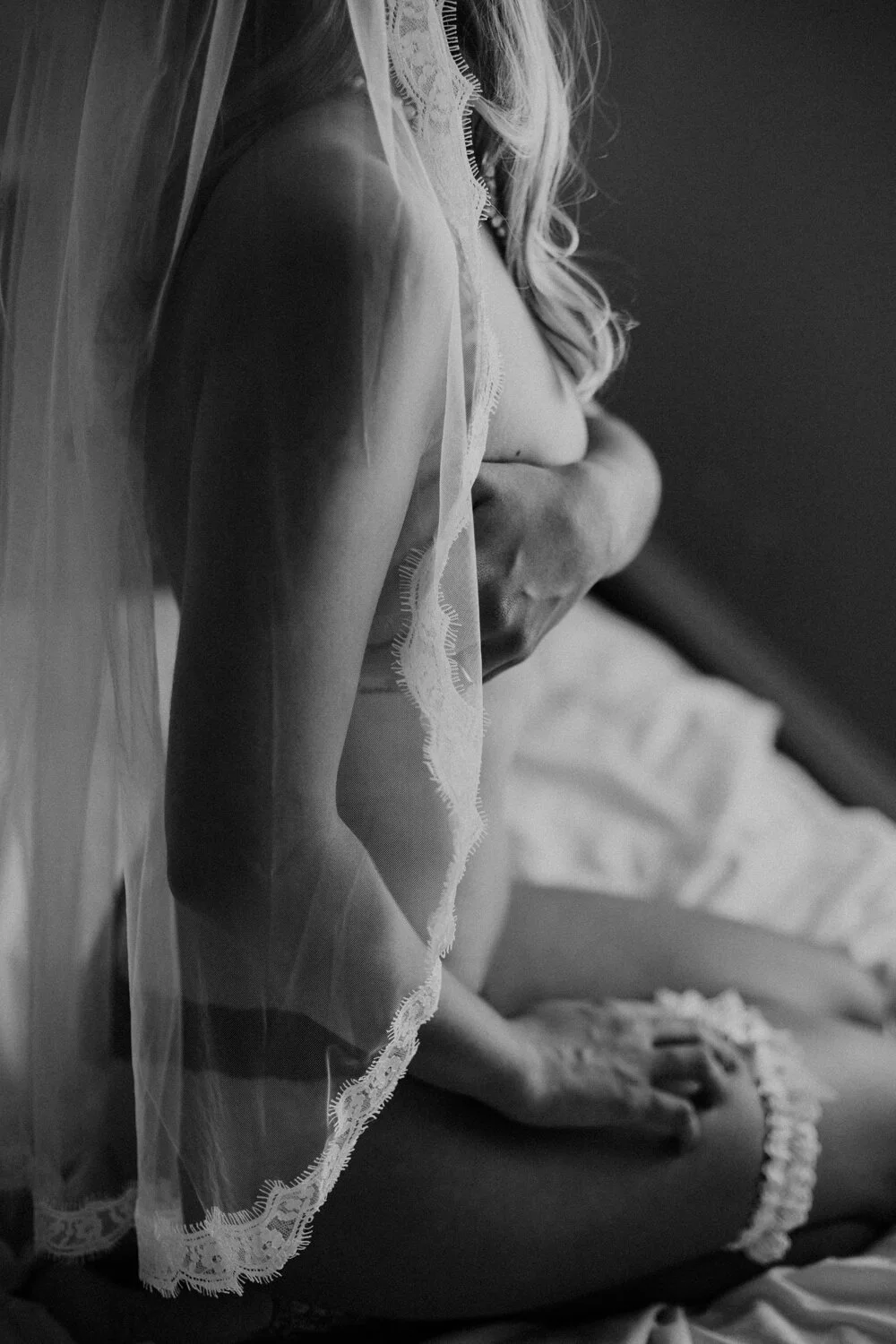  Bridal boudoir and surprise wedding present. Topless bride in wedding veil and garter.  