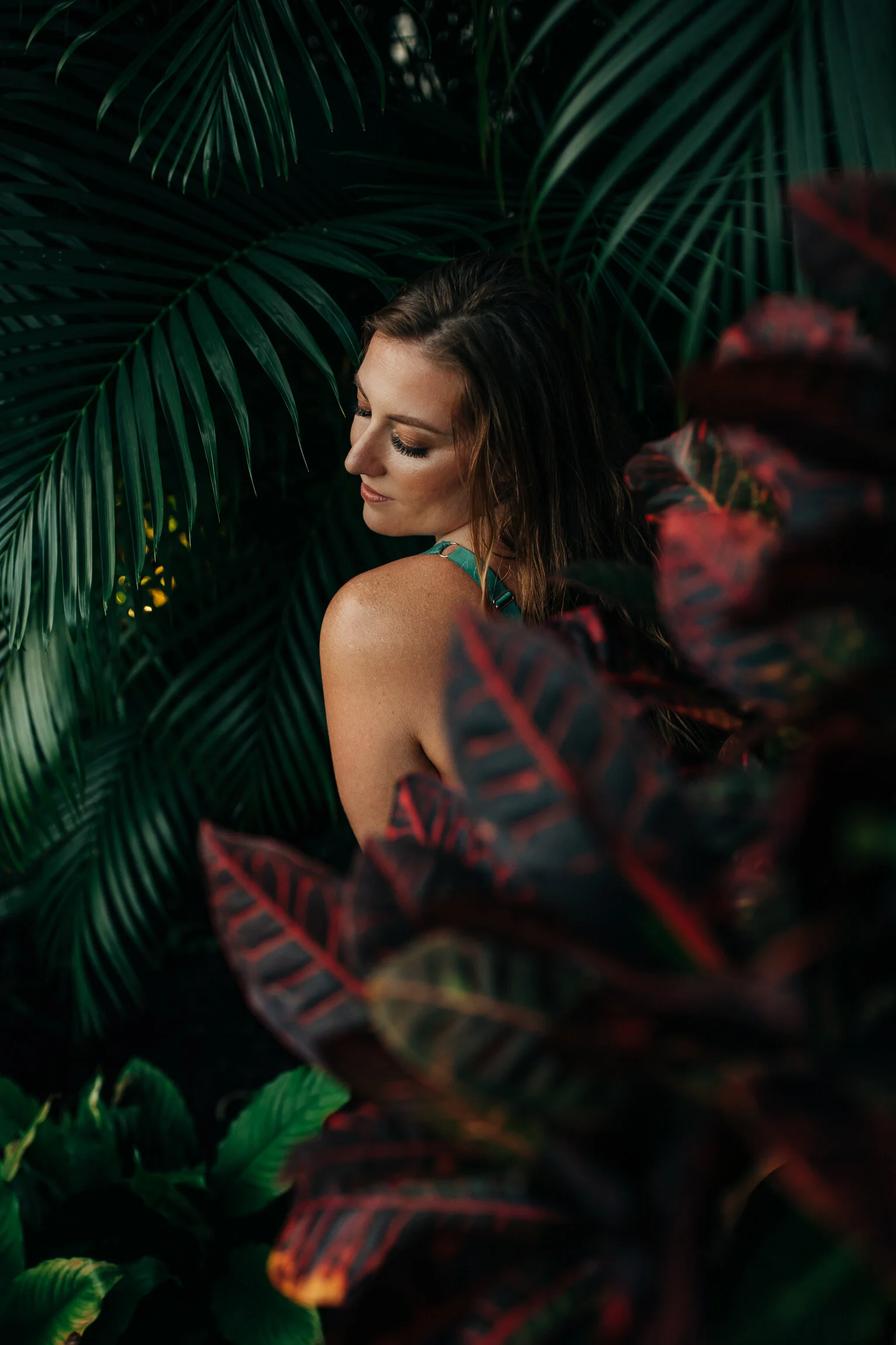  Vibrant colorful outdoor boudoir in tropical garden. Environmental portraiture on Oahu, Hawaii.  