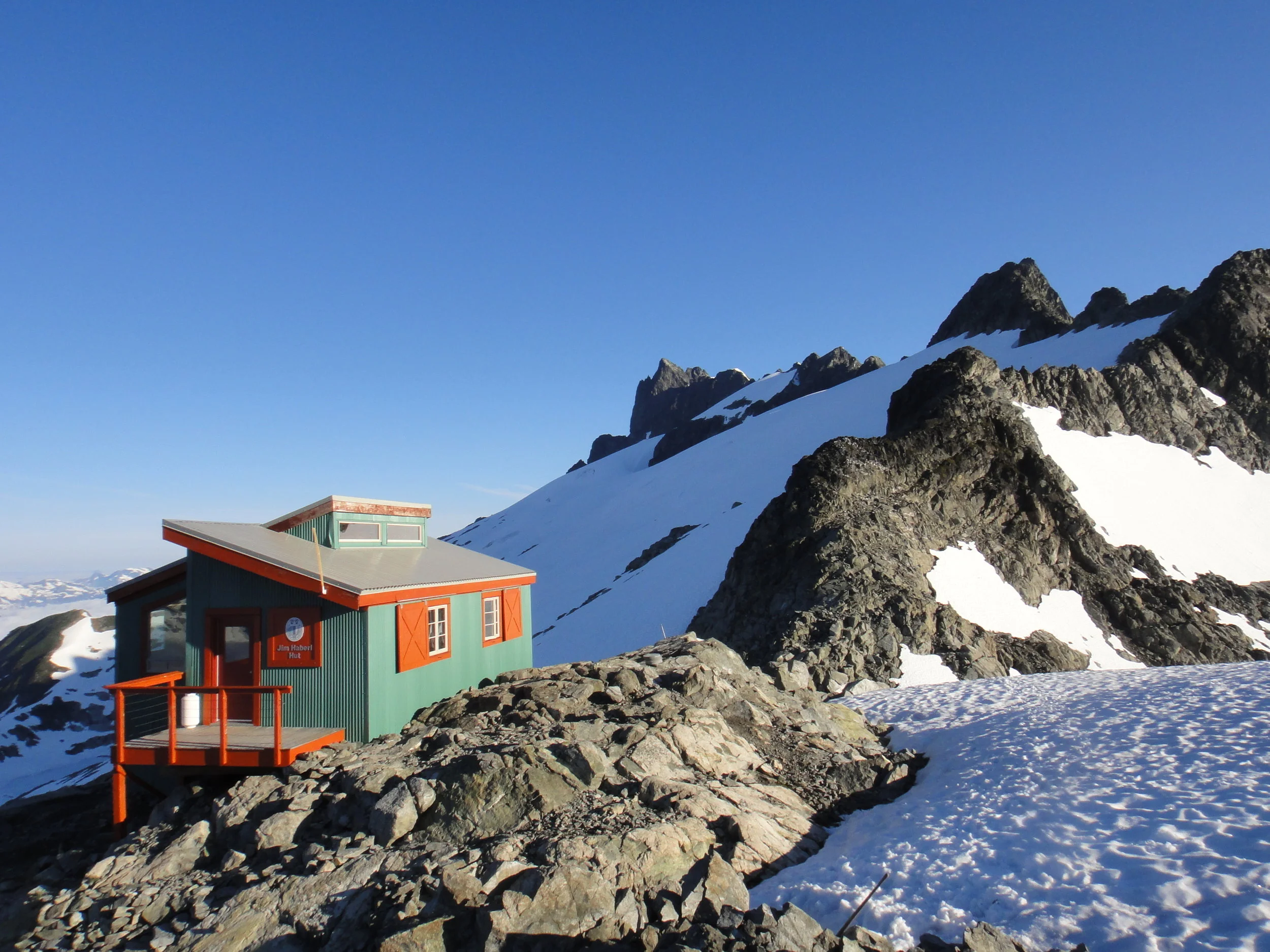 Jim Haberl Hut (Serratus Col): For the higher, more remote Tantalus ridge area, from the Jim Haberl Hut at 6,700ft, to the Zenith col, Mt Dione, the Alpha ridge and Mt Ossa, allowing you and your group to access new heights for Alpine climbing and skiing in both summer and winter. Cost: $600 one way, $1200 round trip - for up to 5 passengers Click Here to reserve the cabin.