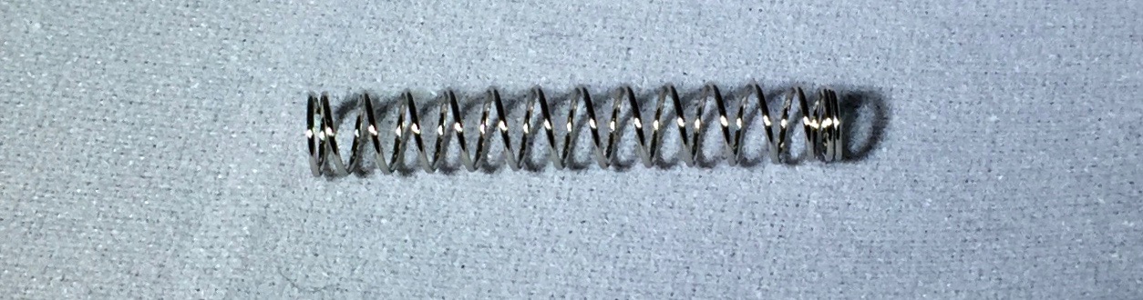 The steel spring holds the refill inside the pen.