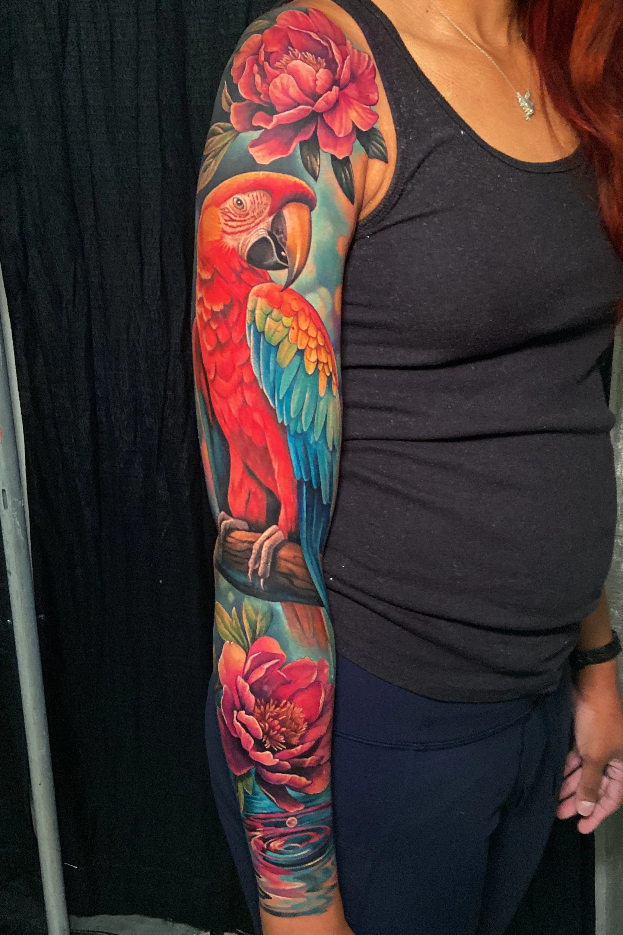 Adriana-hallow-tattoo-Melanated-skin-color-realism-nyc-macaw-peony-sleeve.png