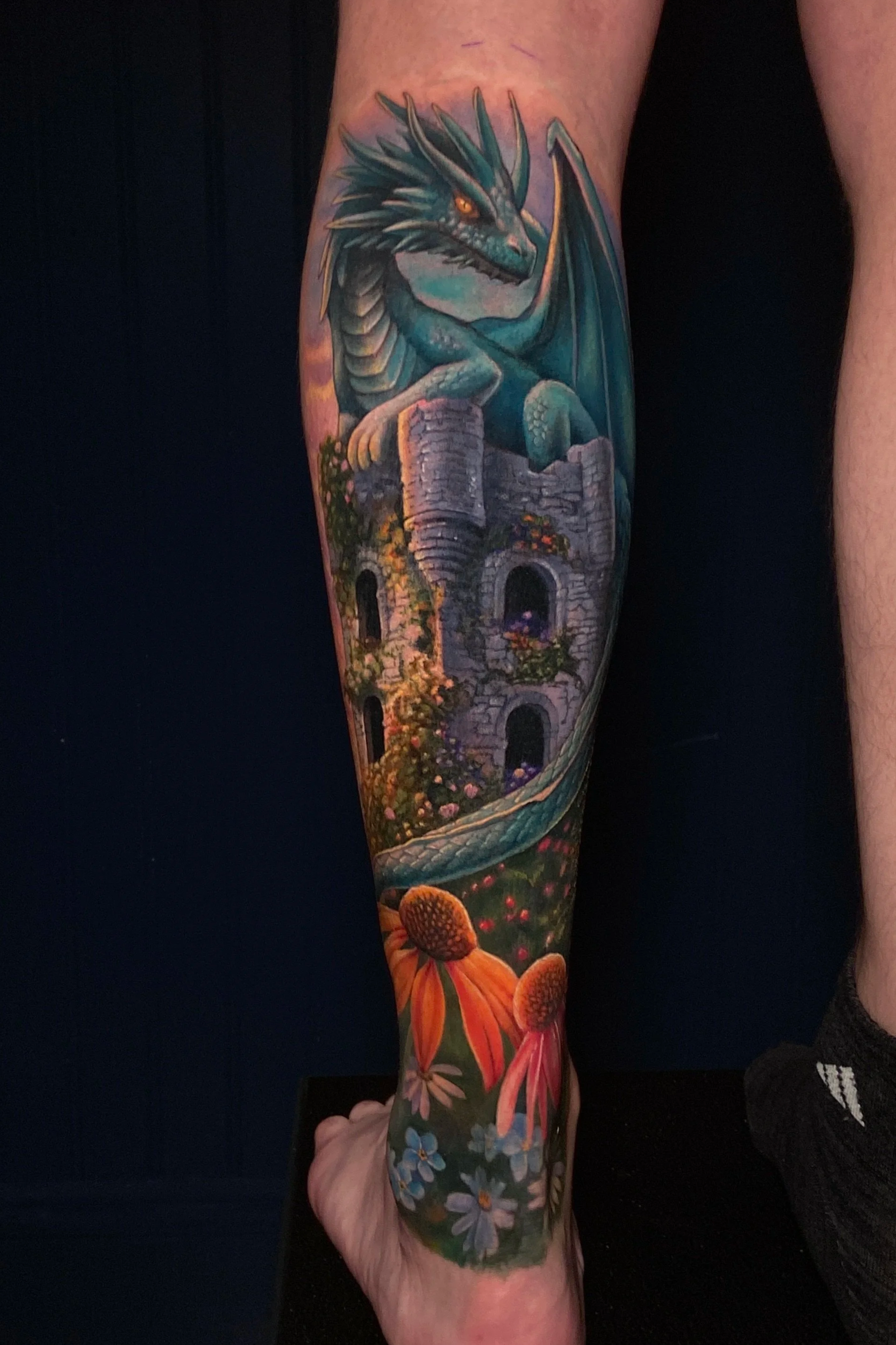 Adriana-hallow-tattoo-Melanated-skin-color-realism-nyc-dragon-tower-coneflower.png