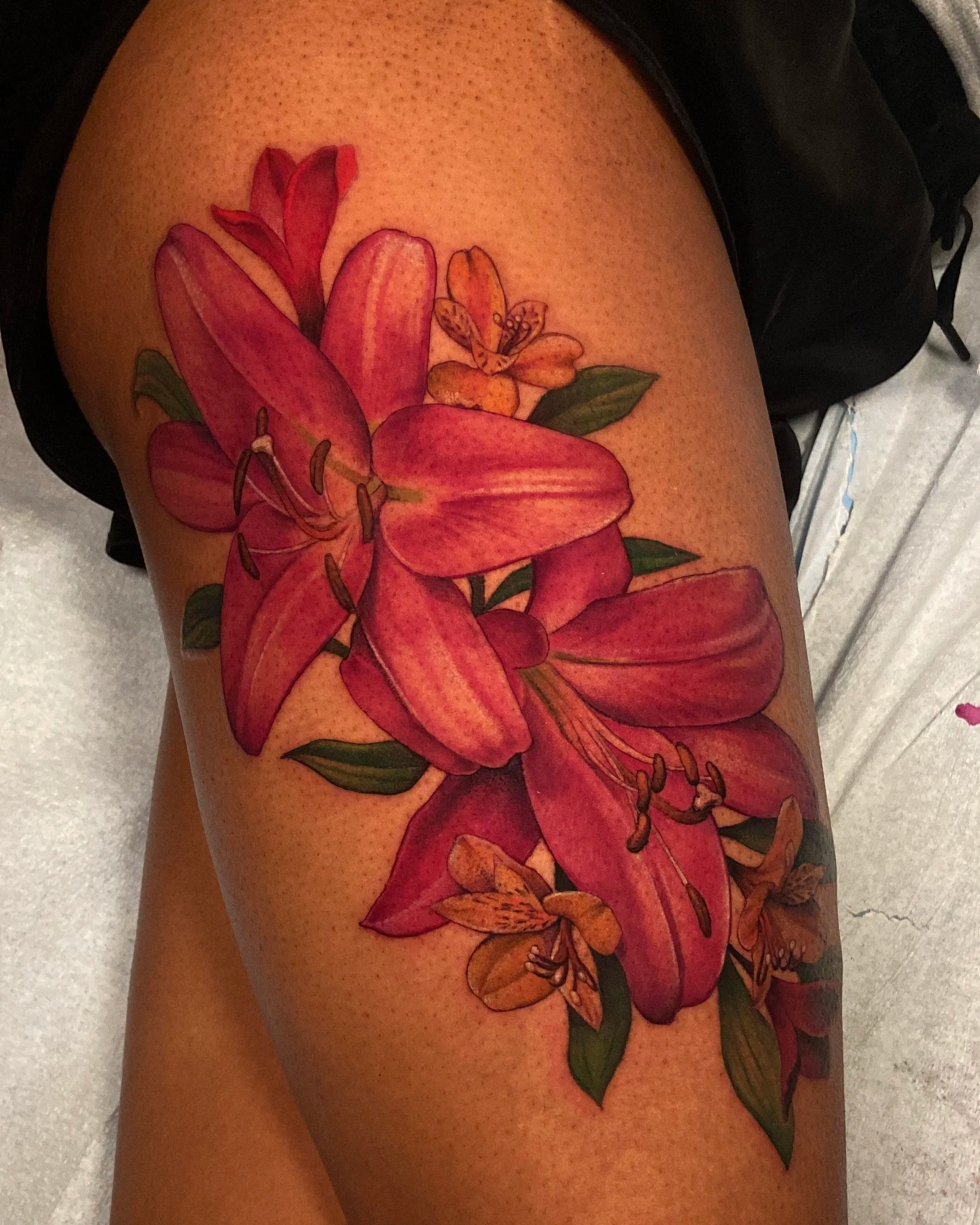 Adriana-hallow-tattoo-Melanated-skin-color-realism-nyc-lily-thigh-piece.png