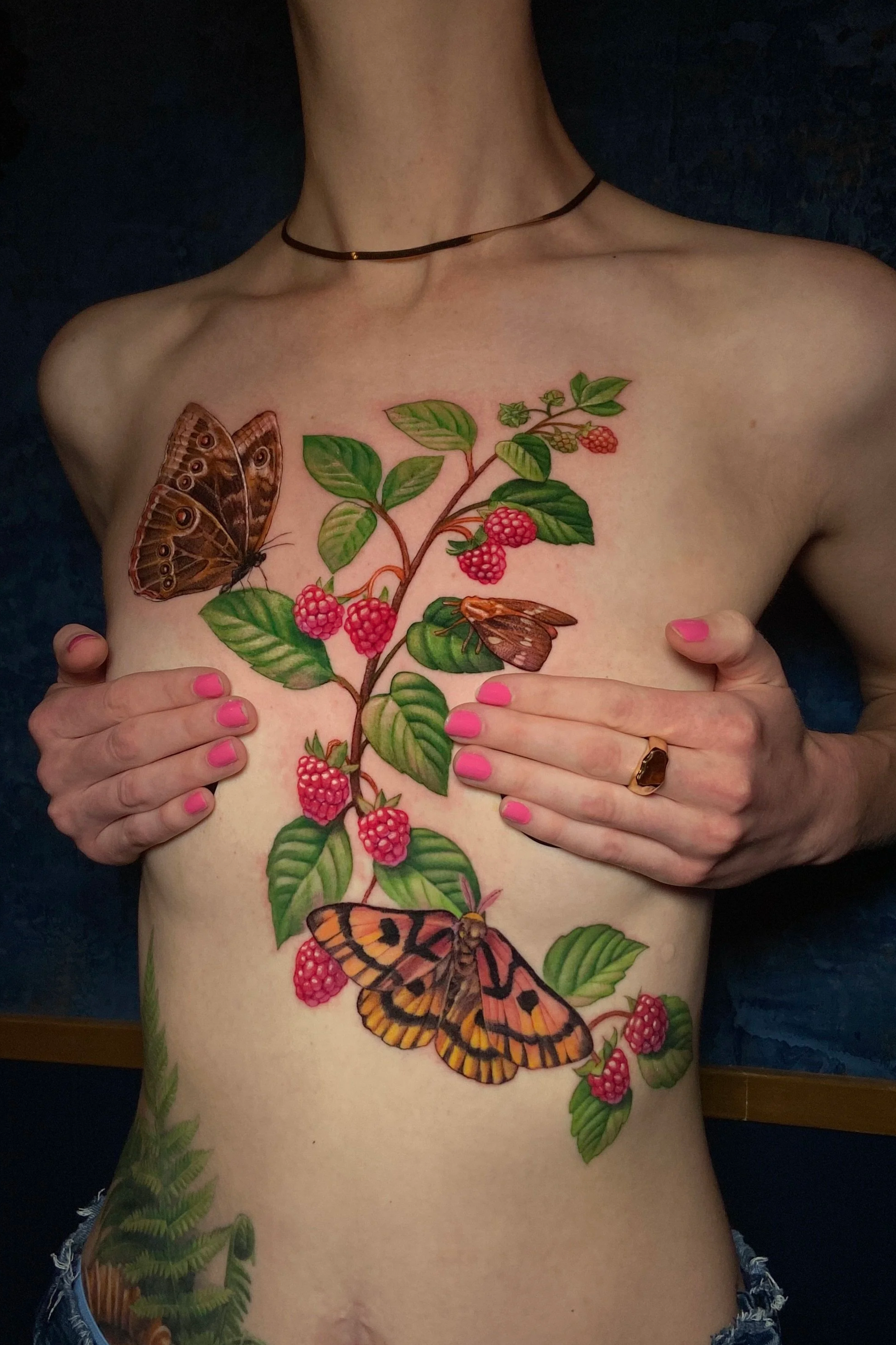Adriana-hallow-tattoo-Melanated-skin-color-realism-nyc-raspberry-moth-chest-piece.png