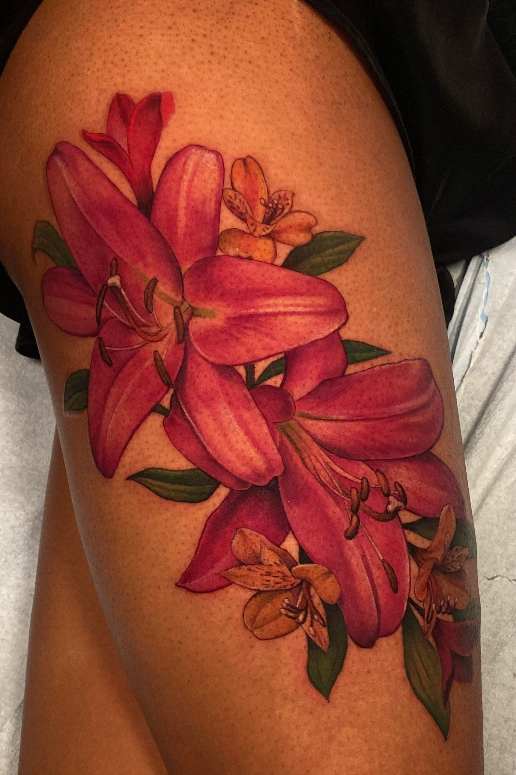 Adriana-hallow-tattoo-Melanated-skin-color-realism-nyc-lily-thigh-piece.png