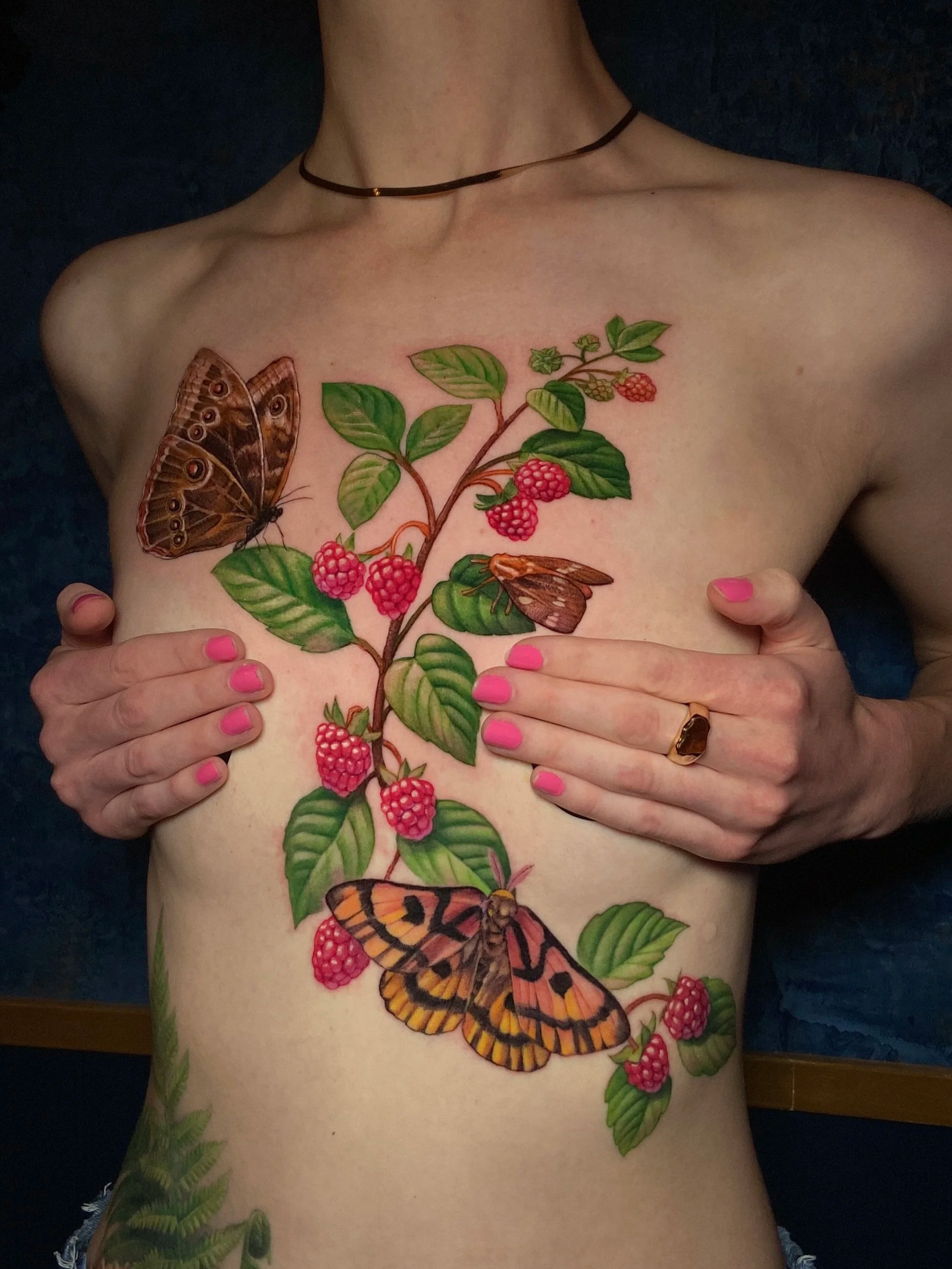 Adriana-hallow-tattoo-Melanated-skin-color-realism-nyc-raspberry-moth-chest-piece.png
