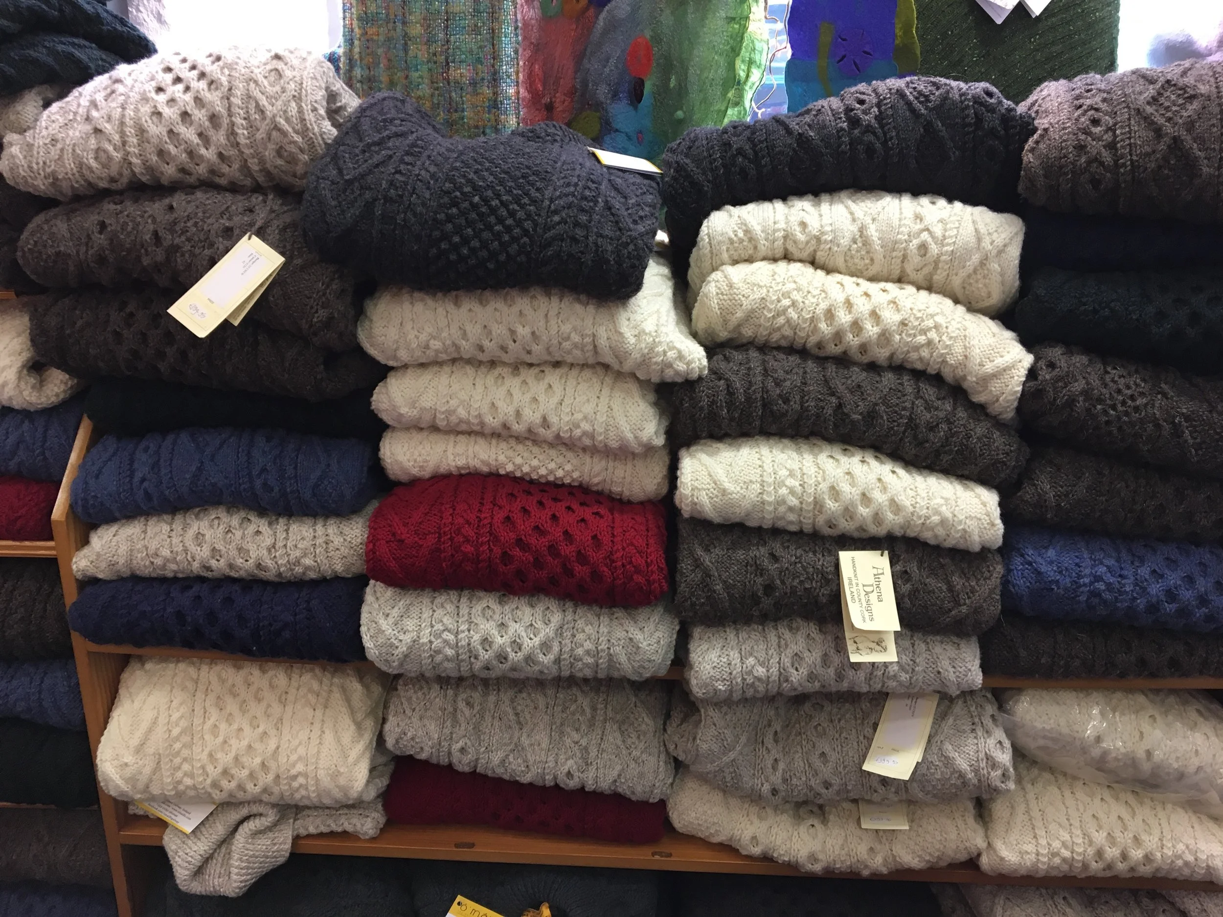 Stacks and stacks of handknit sweaters. 