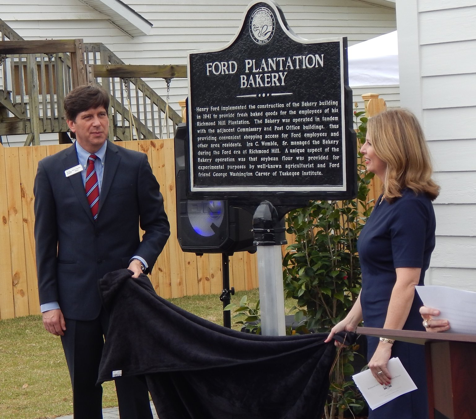 Mayor Russ Carpenter (left) and Christy Sherman of the CVB unveil the historical marker. Photo by Mark Swendra.
