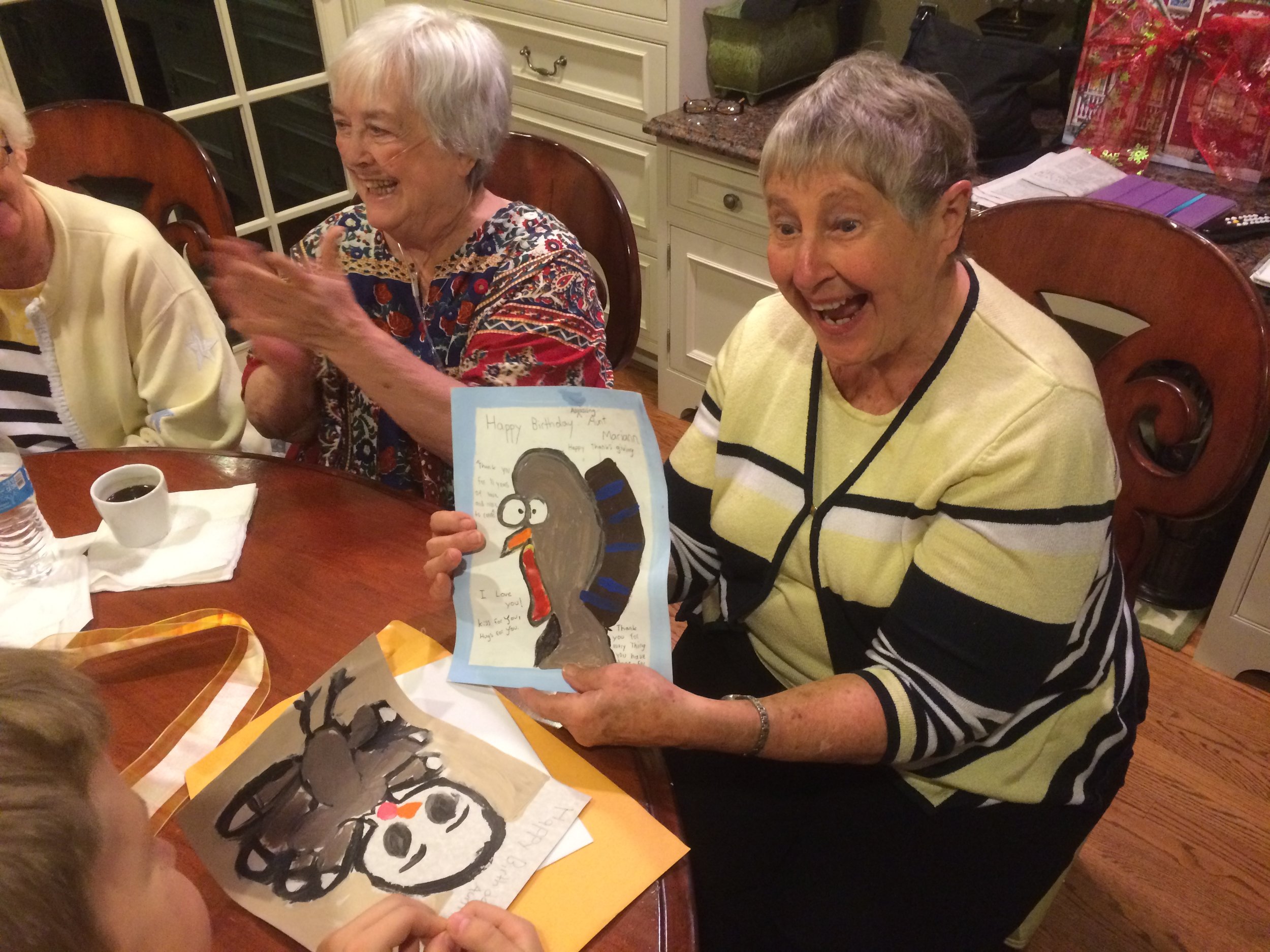  Aunt Marianne (next to Tom's monther) enjoying Tom's nephew's Thanksgiving art 