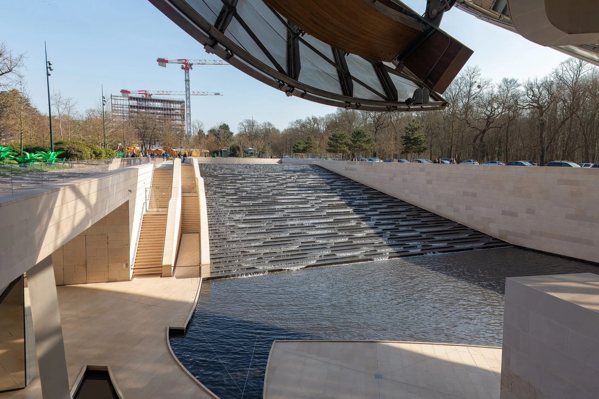  Looking back at the fountain that blends into the lower layers of the building, with the lighted walkway, shown earlier hidden under the structure to the left 