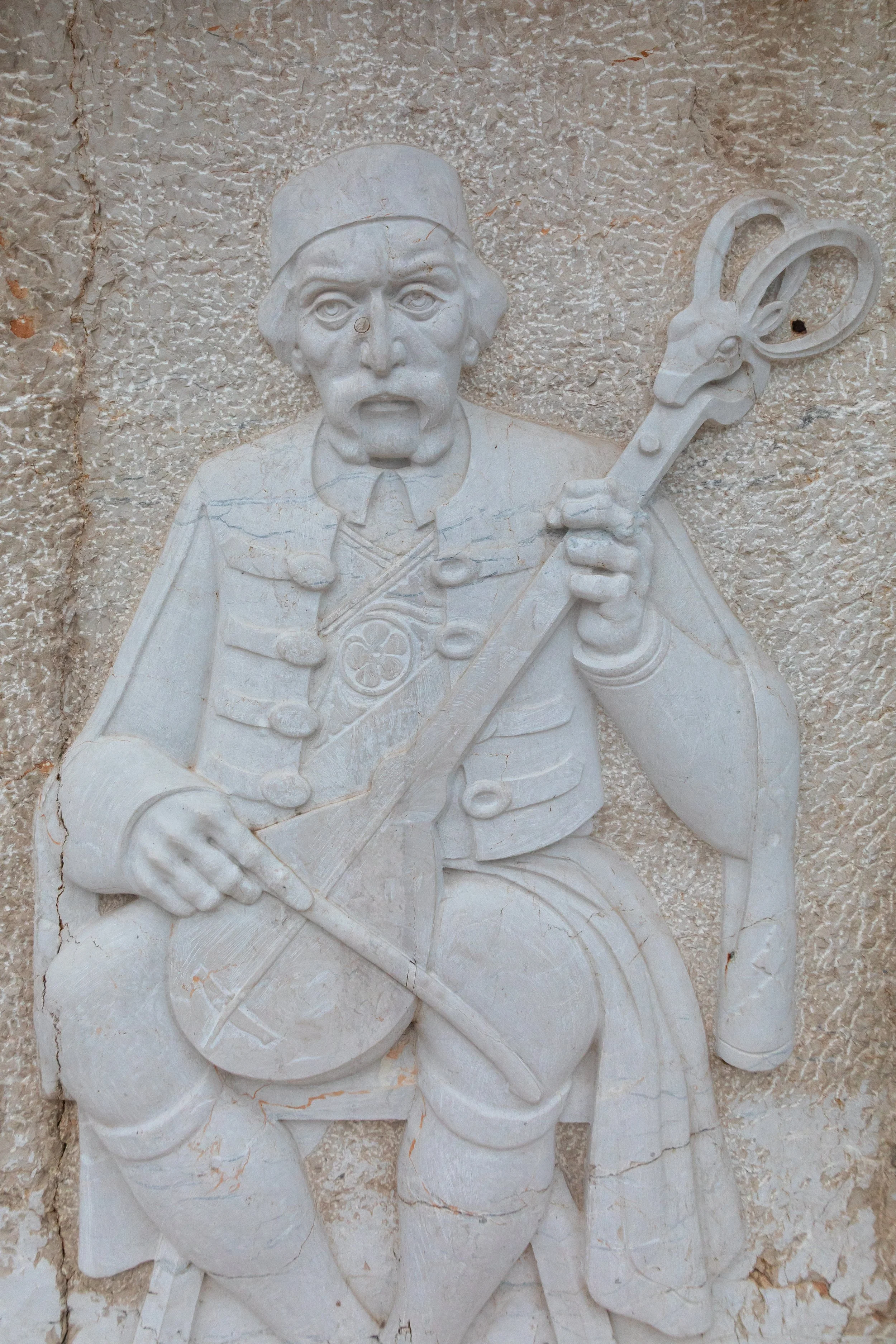  Relief of a traditional guslar, a significant cultural icon in the Balkans, particularly among Serbs and Montenegrins 