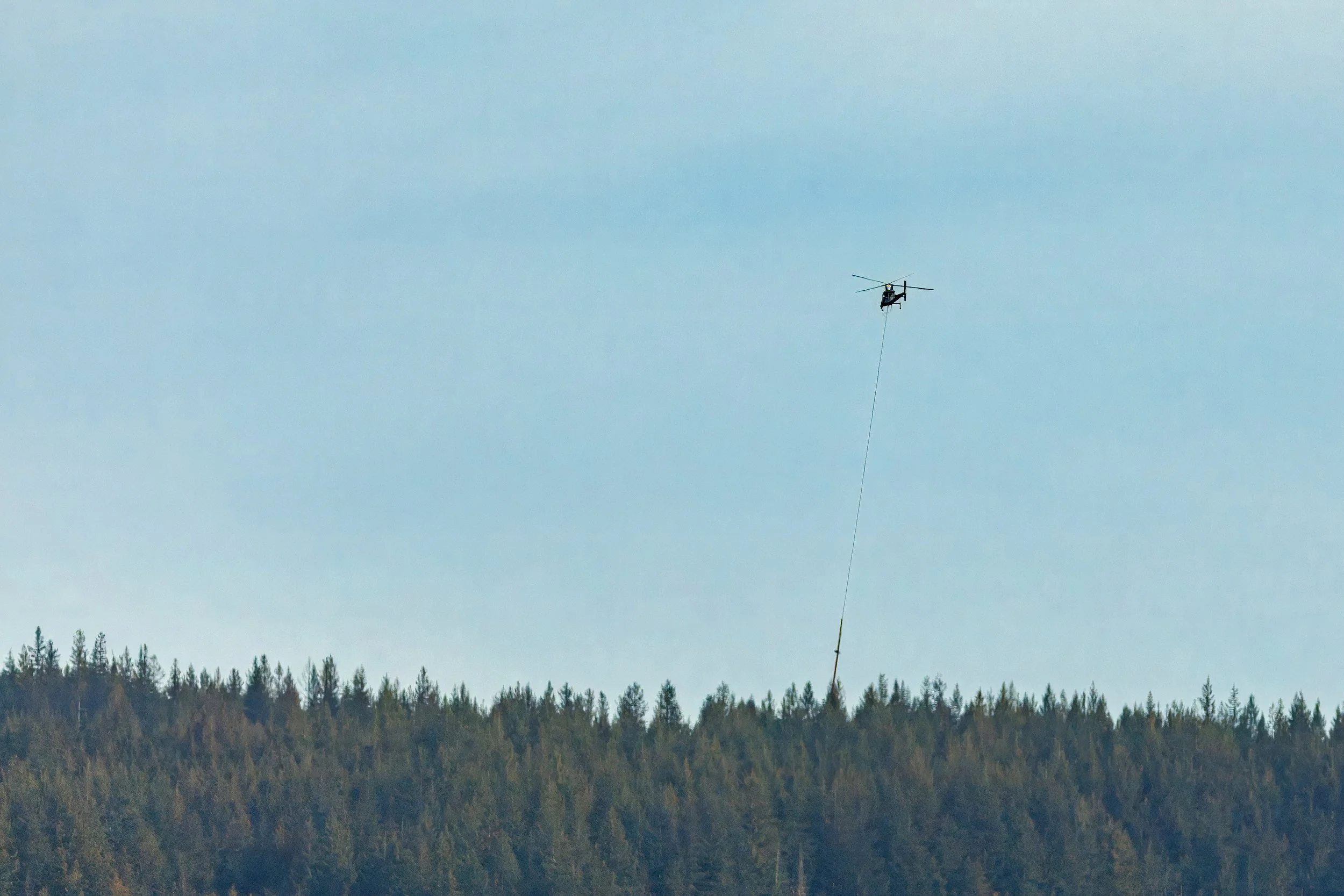  Looking across Porpoise Bay we watch a helicopter logging operation 