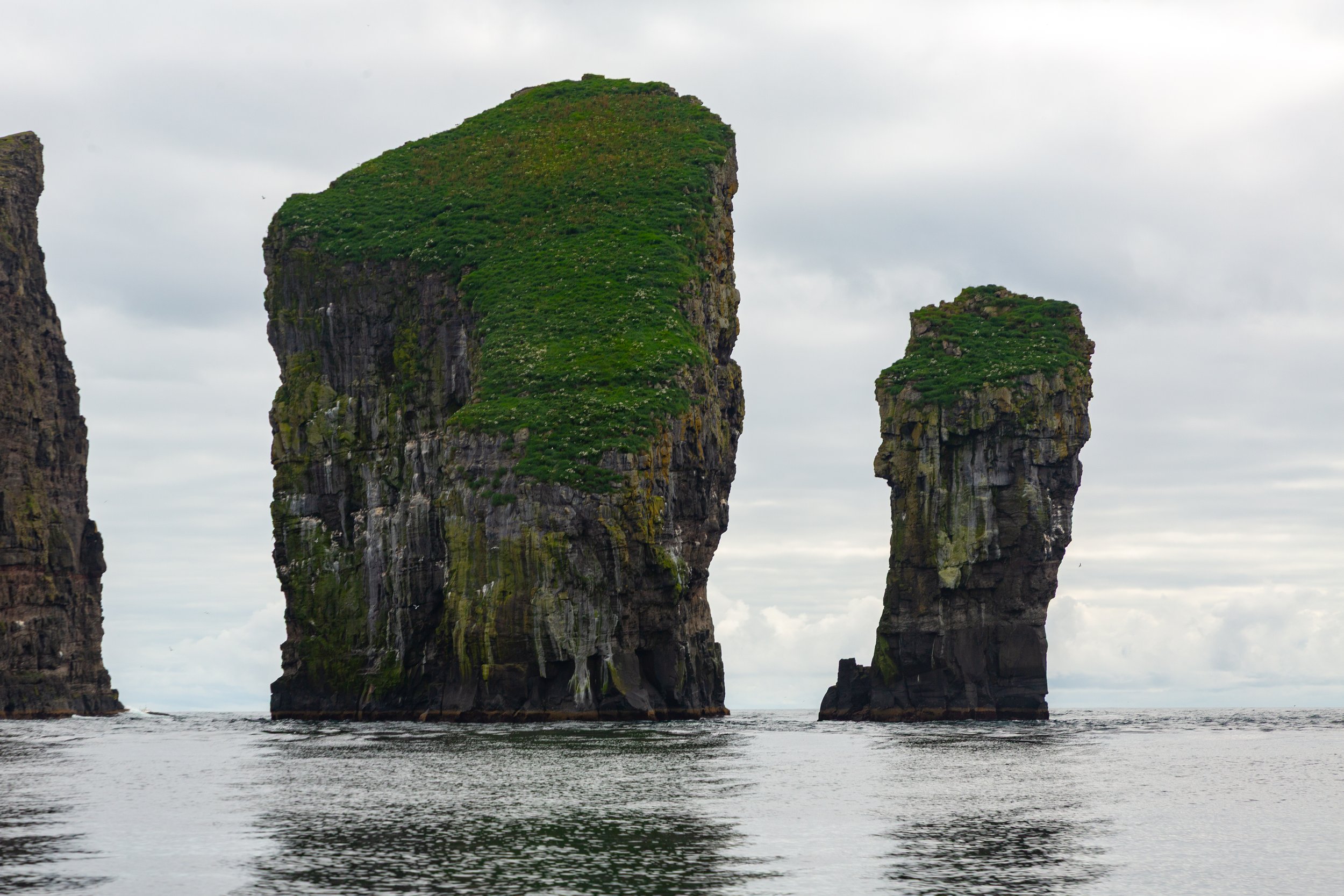  Circling around Drangarnir, a pair of iconic sea stacks, literally translated to sea stacks in English  