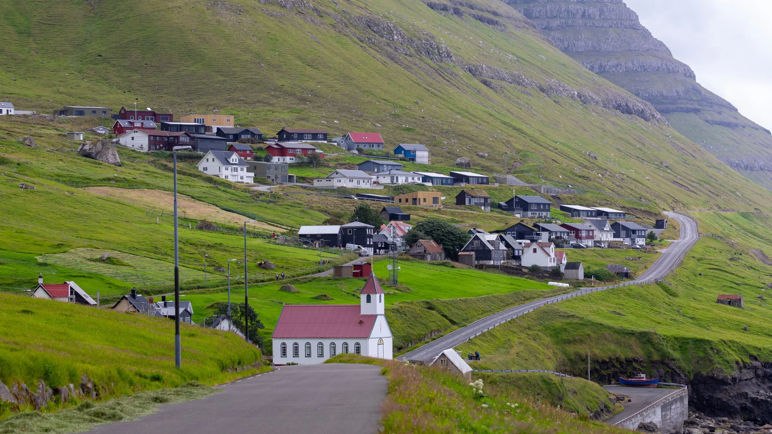  After a brief walk, we get more of perspective of the town of Kunoy, hugging the rugged coastline 