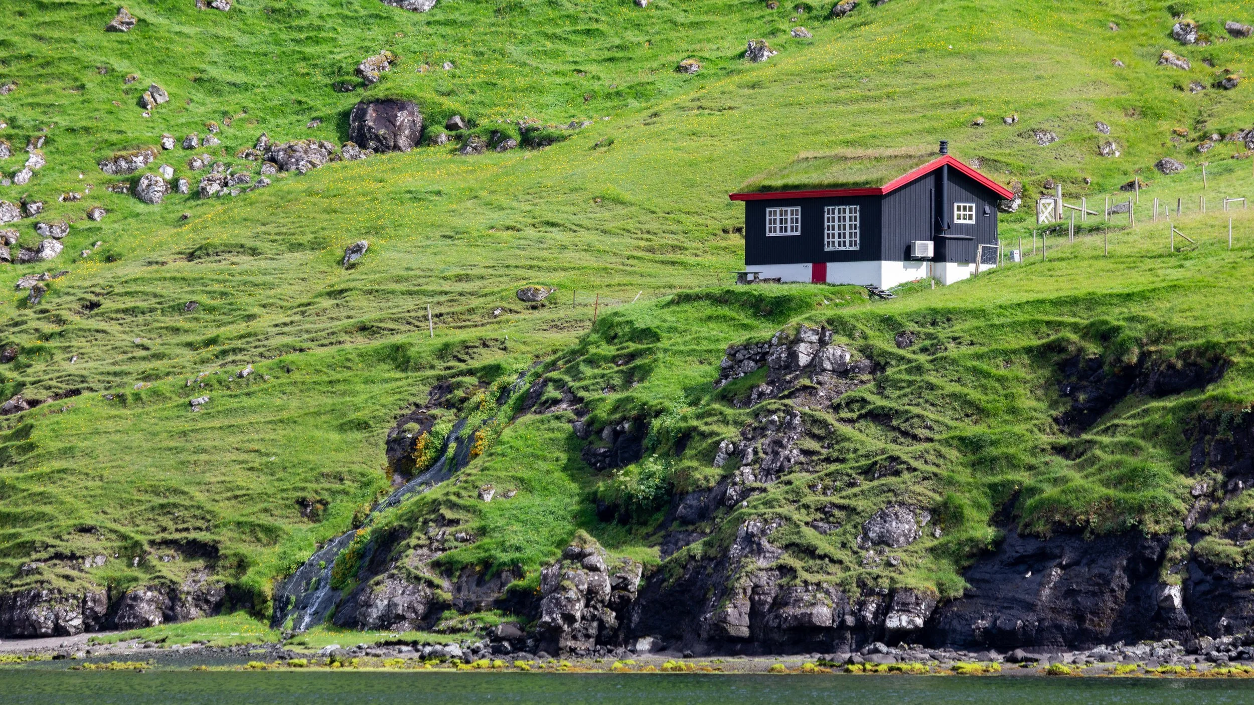  Traditional turf house on the edge of the lagoon 