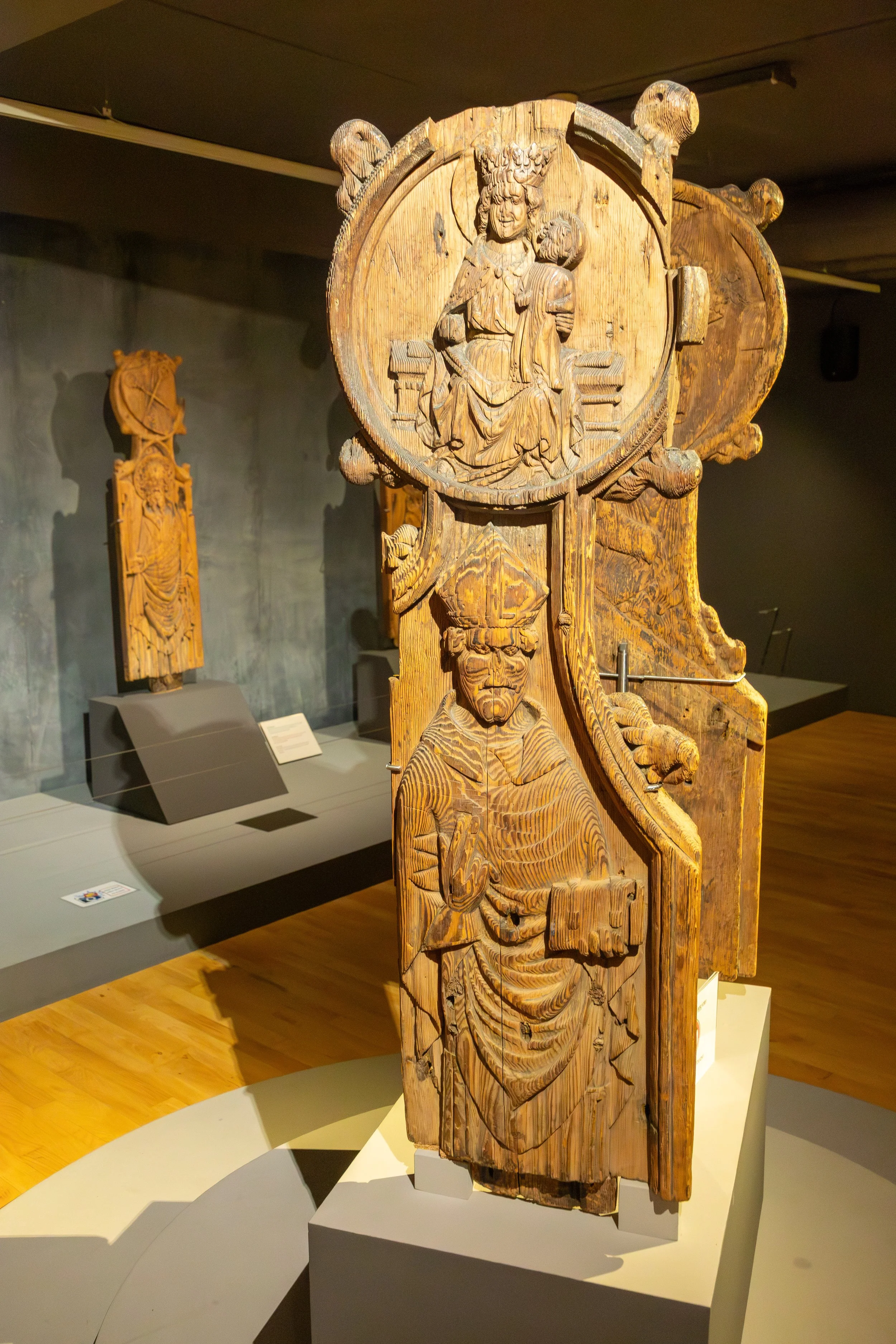  Two 15th-century Kirkjubøur intricately carved wooden panel pew ends originally belonged to Saint Olav's Church in Kirkjubøur, displayed with other artifacts in the museum 