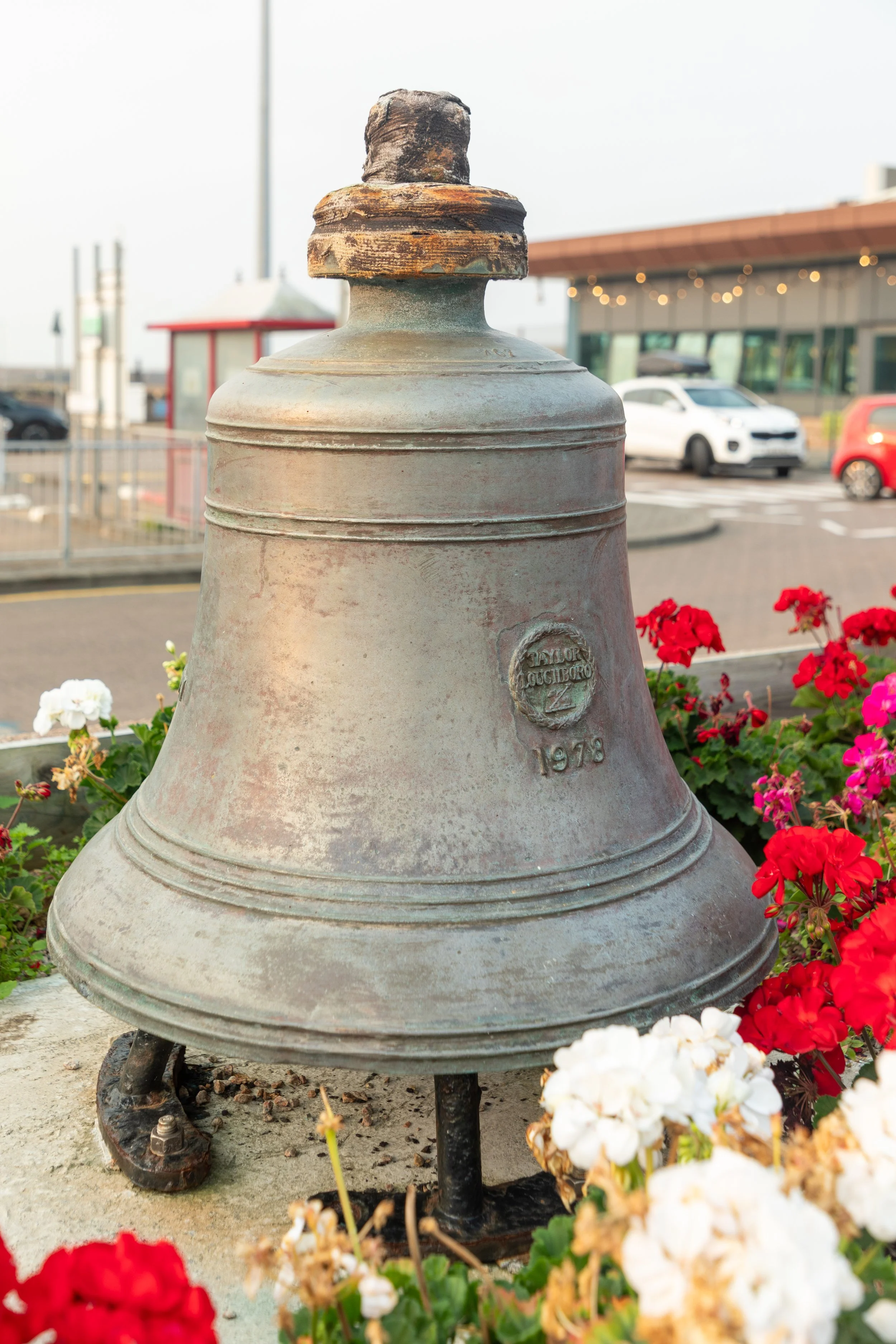  Admiring a ship’s bell near the ferry terminal at Jersey port, as we wait for our ferry to board 
