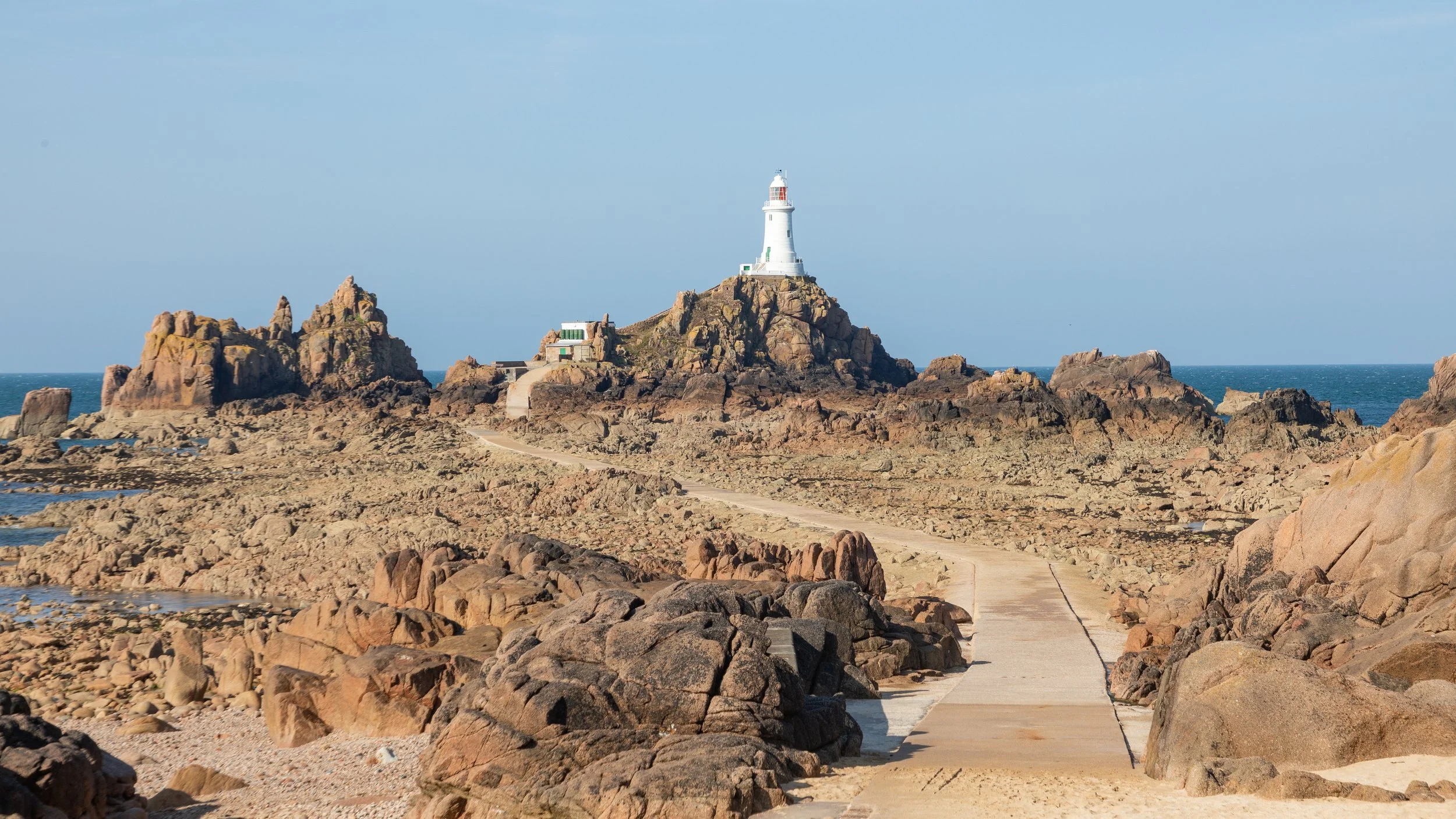  Back at La Corbiere concrete lighthouse with blue skies to provide a low tide reference 