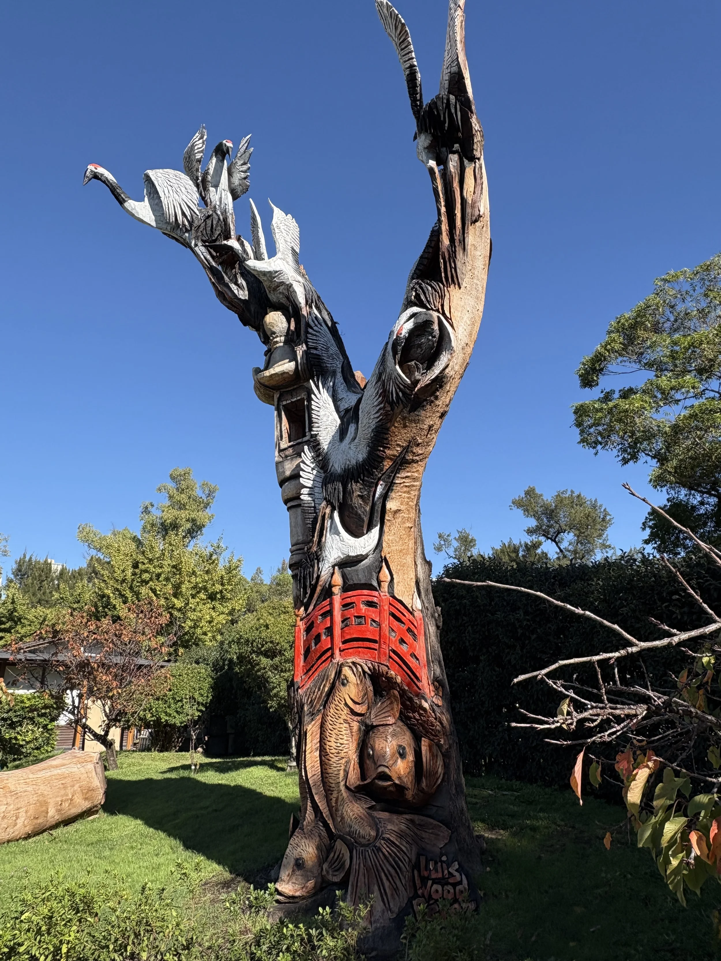  Tree sculpture featuring various carvings of birds and fish carved from the trunk of a large tree 