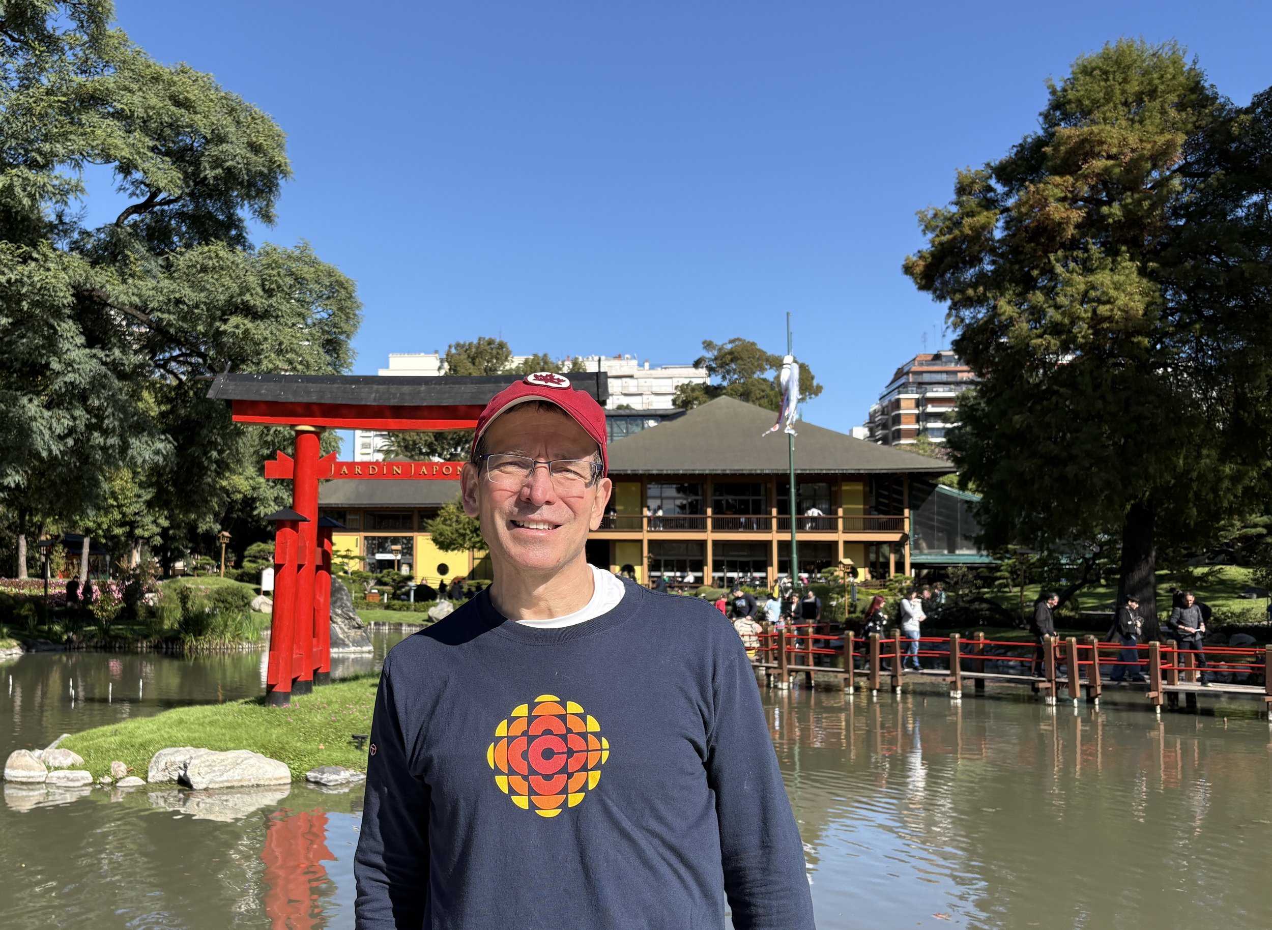  Standing in front of pond with Traditional Torii gate 