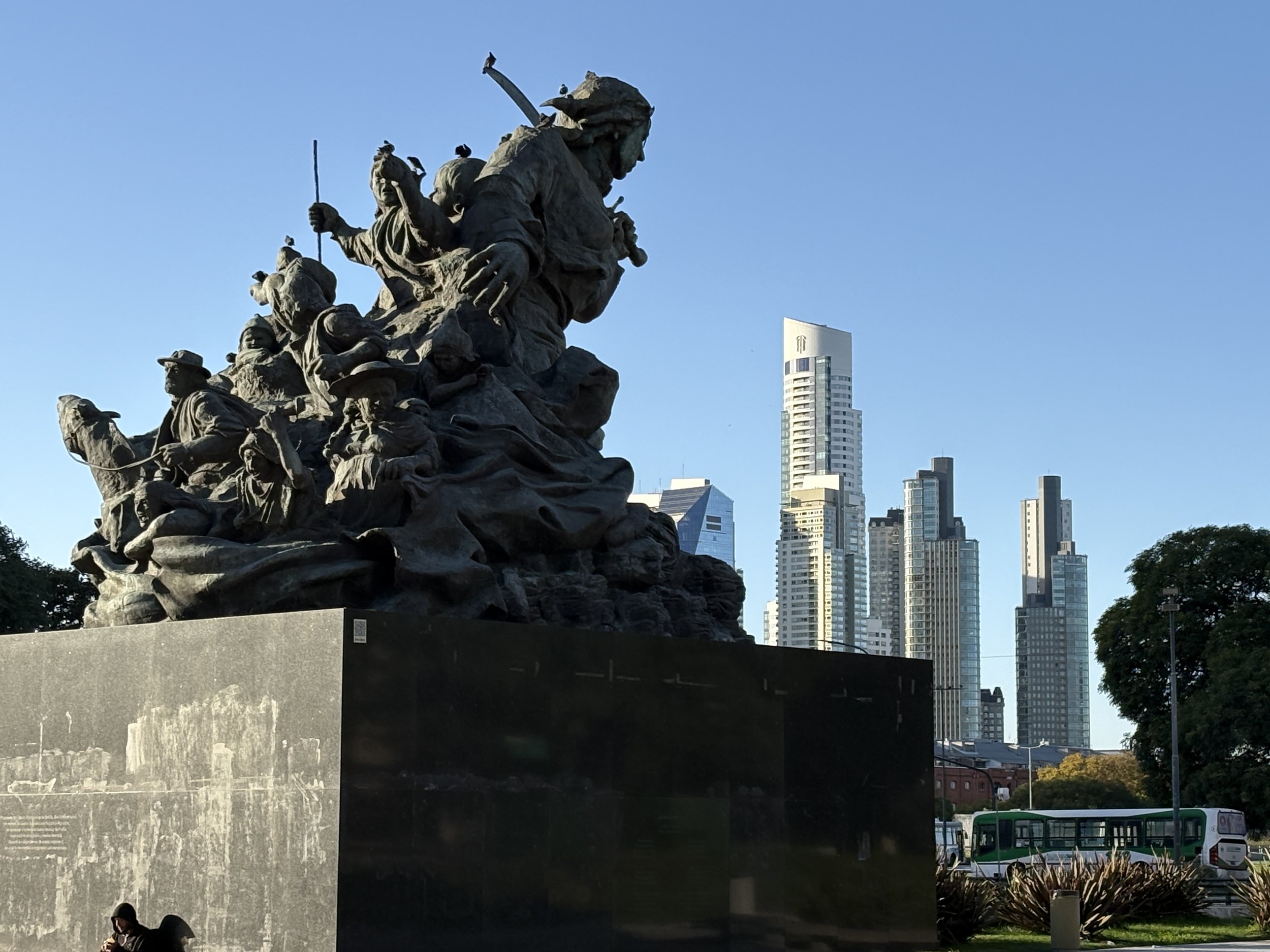  The statue of Juan Azurduy in the Plaza de Correo in front of the Libertad Palace with the towers of Puerto Madero in the background 