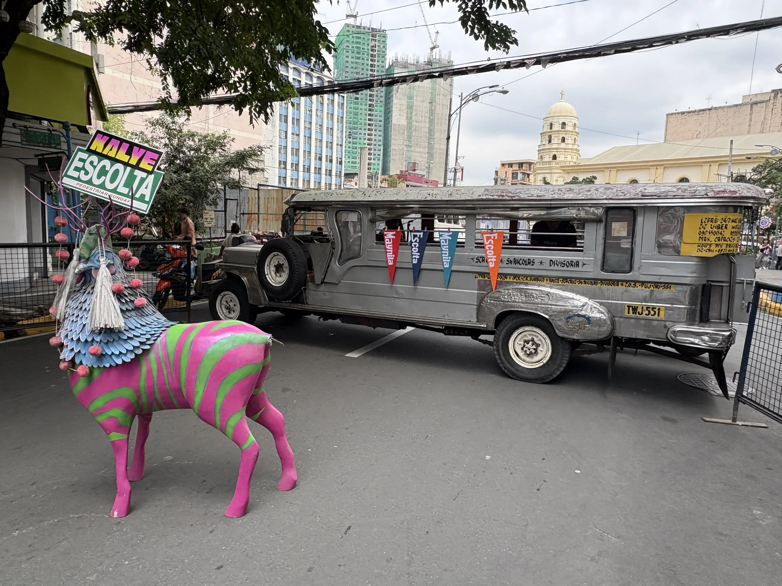  Colourful Escolta Street, closed to vehicles for a pedestrian Sunday of art and culture, with a parked jeepney helping to keep the street closed 