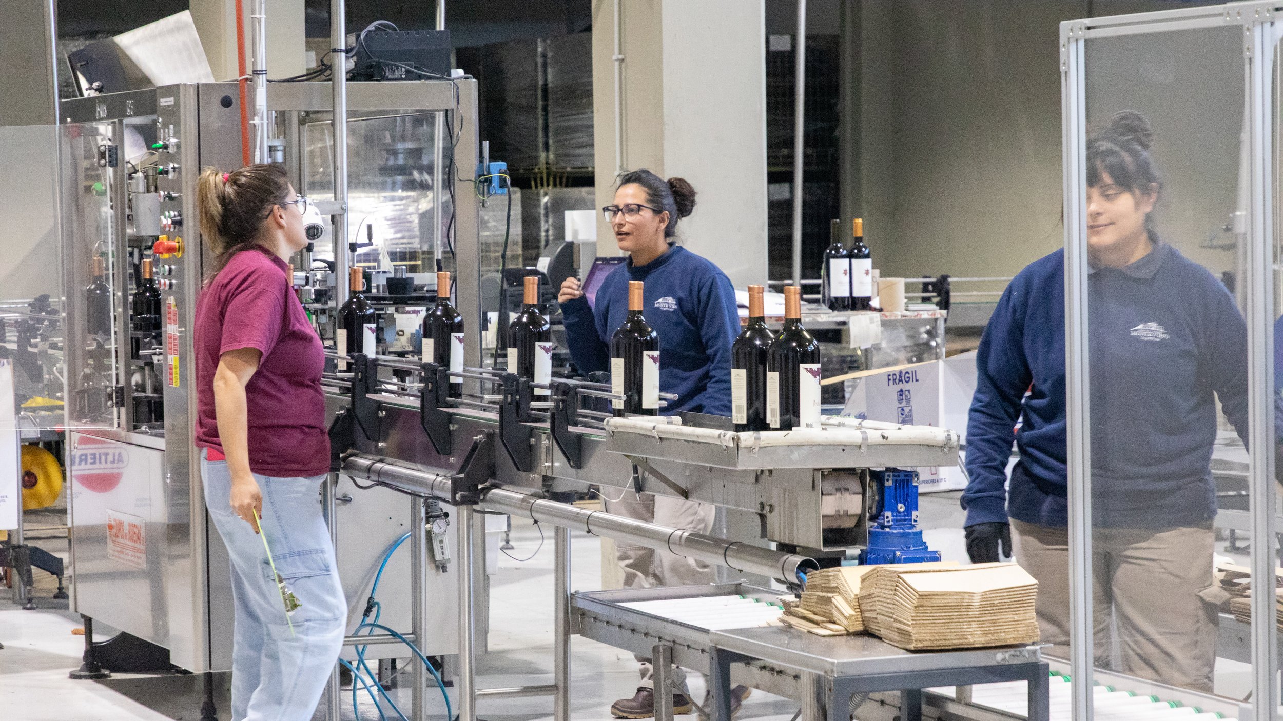  Watching the labeling and packing processes.  We learned that the labels are applied only right before packing and shipping, as aging labeled bottles tends to damage the labels. 