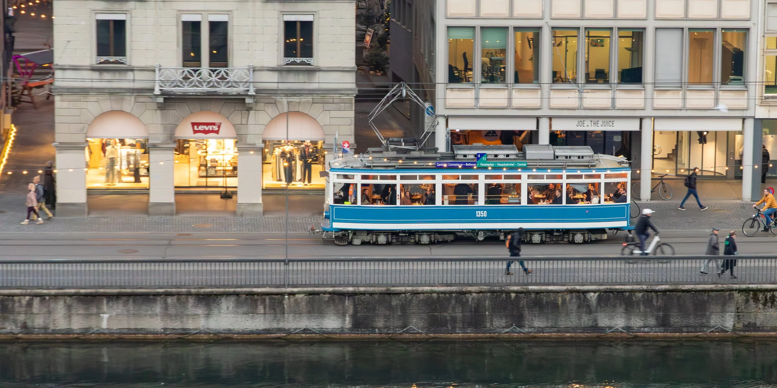  Looking across the Limmat River to a tram traveling along the shore 