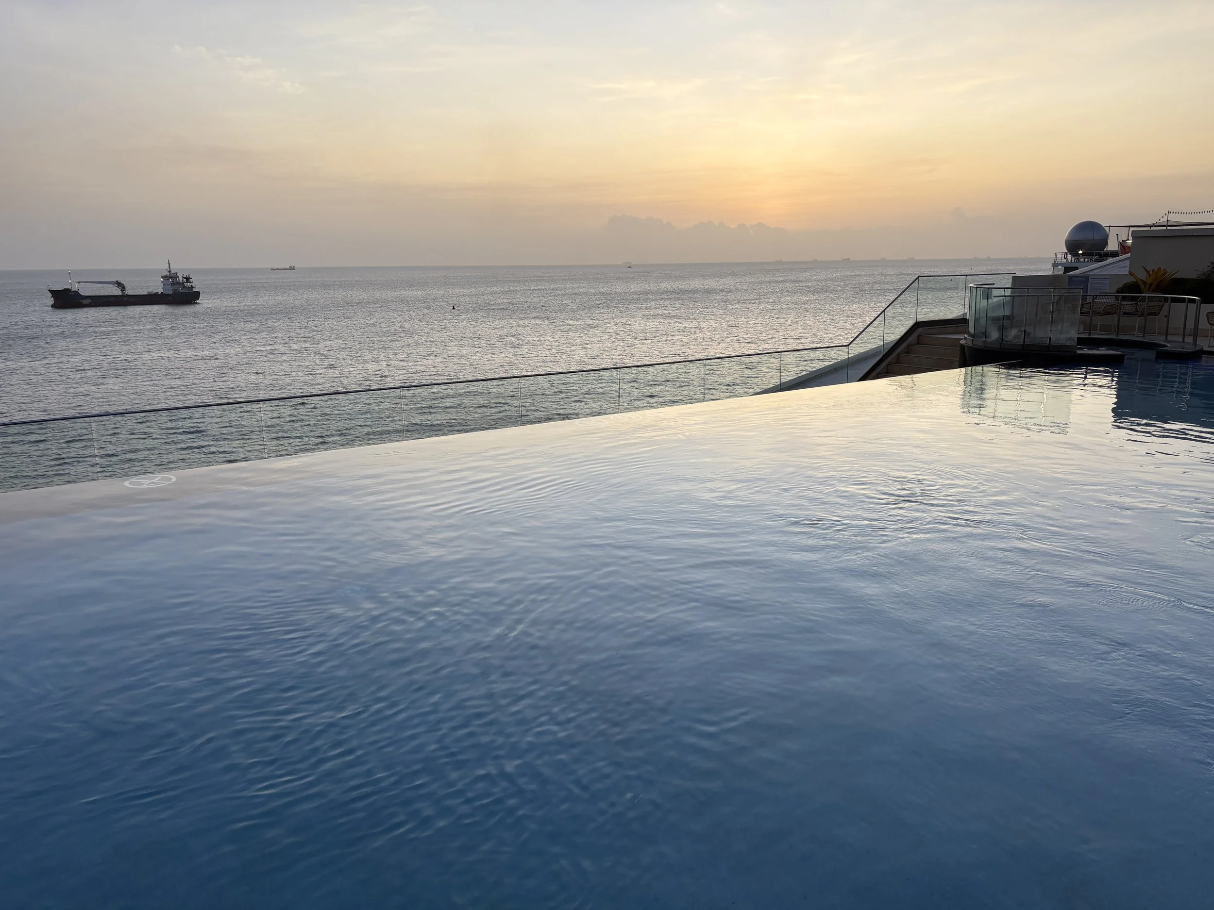  After a lazy day, the sunset over the edge of the hotel’s infinity pool 