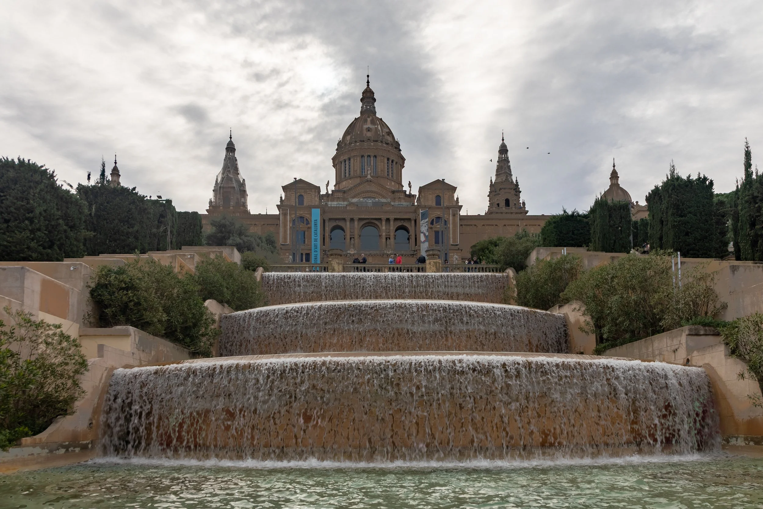  Looking up at Museu Nacional d'Art de Catalunya across numerous fountains making their way down the hill to Plazas de las Cascadas 