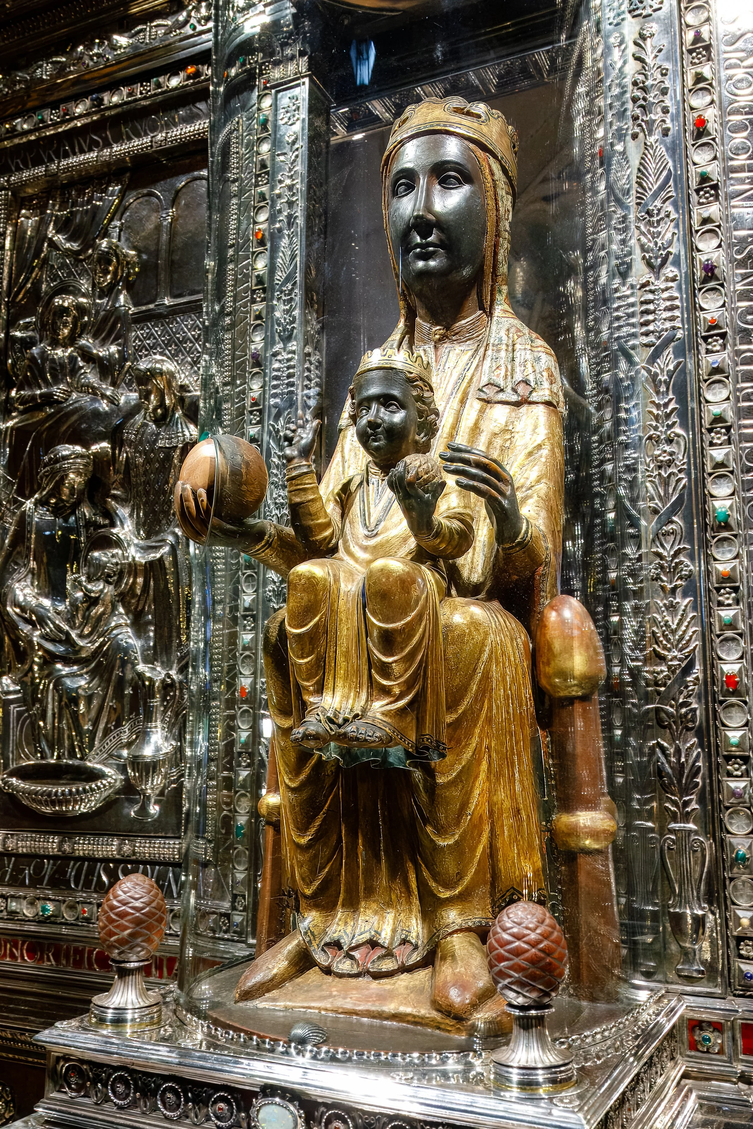  The 800-year-old  Black Virgin  (La Moreneta) is the main draw, and sits high above the altar with its exposed royal orb open to the touch of pilgrims to the site 