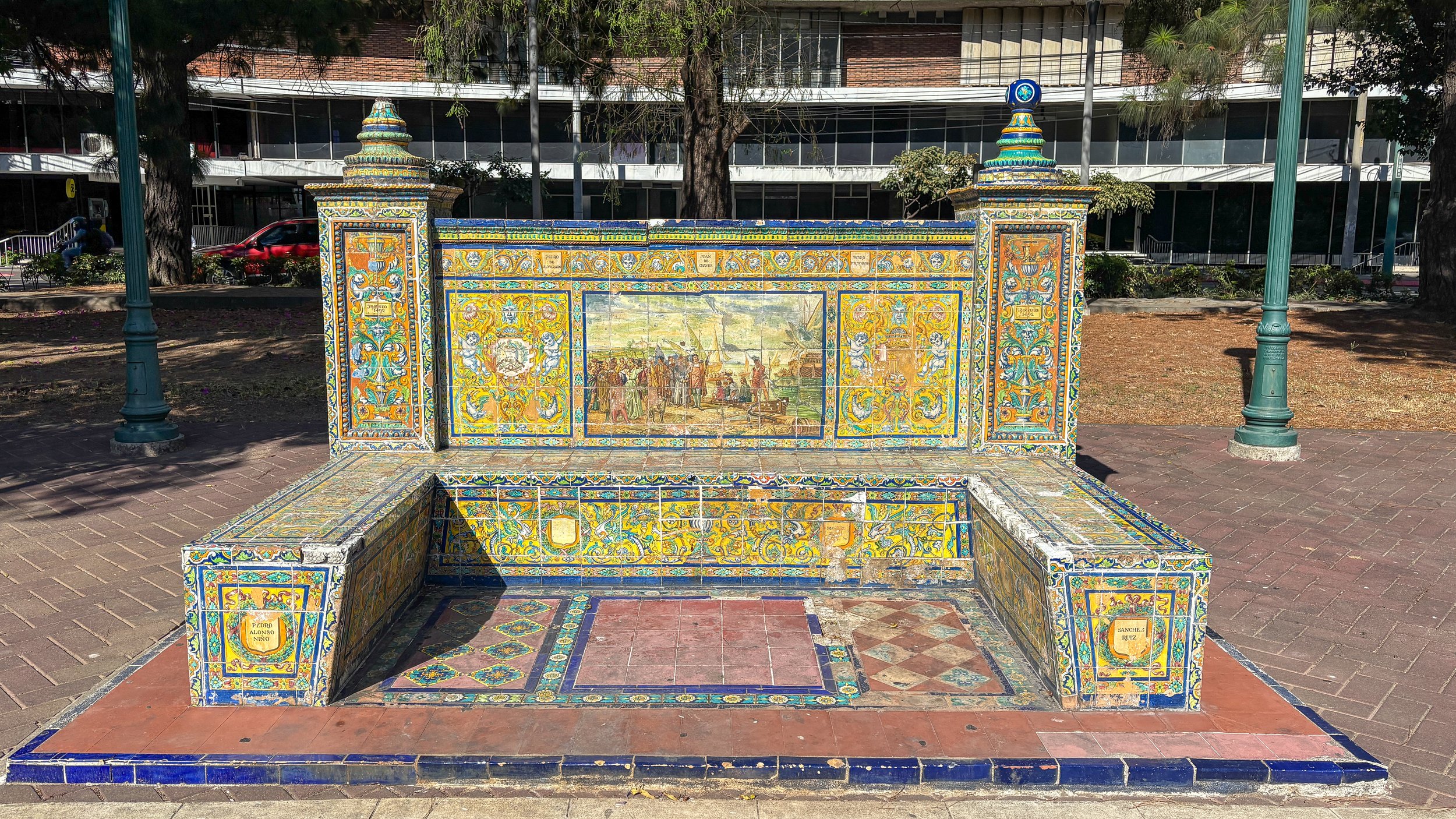  One of the four historic polychrome tile benches in the Plaza, donated to Guatemala by the Spanish government during the  s qu a re's inauguration in 19 3 3, depicted scenes from the European discovery of the Americas 