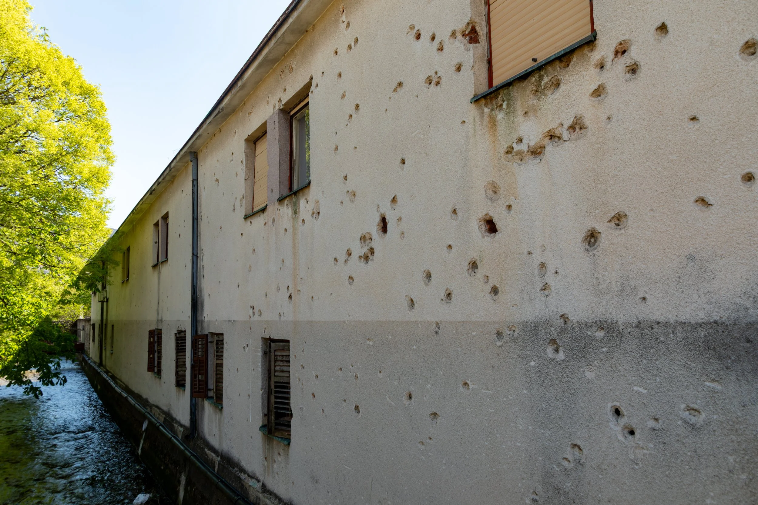  Arriving in Mostar, we noticed that, as in Sarajevo, there are still pockmarks on the buildings from the wartime shelling 