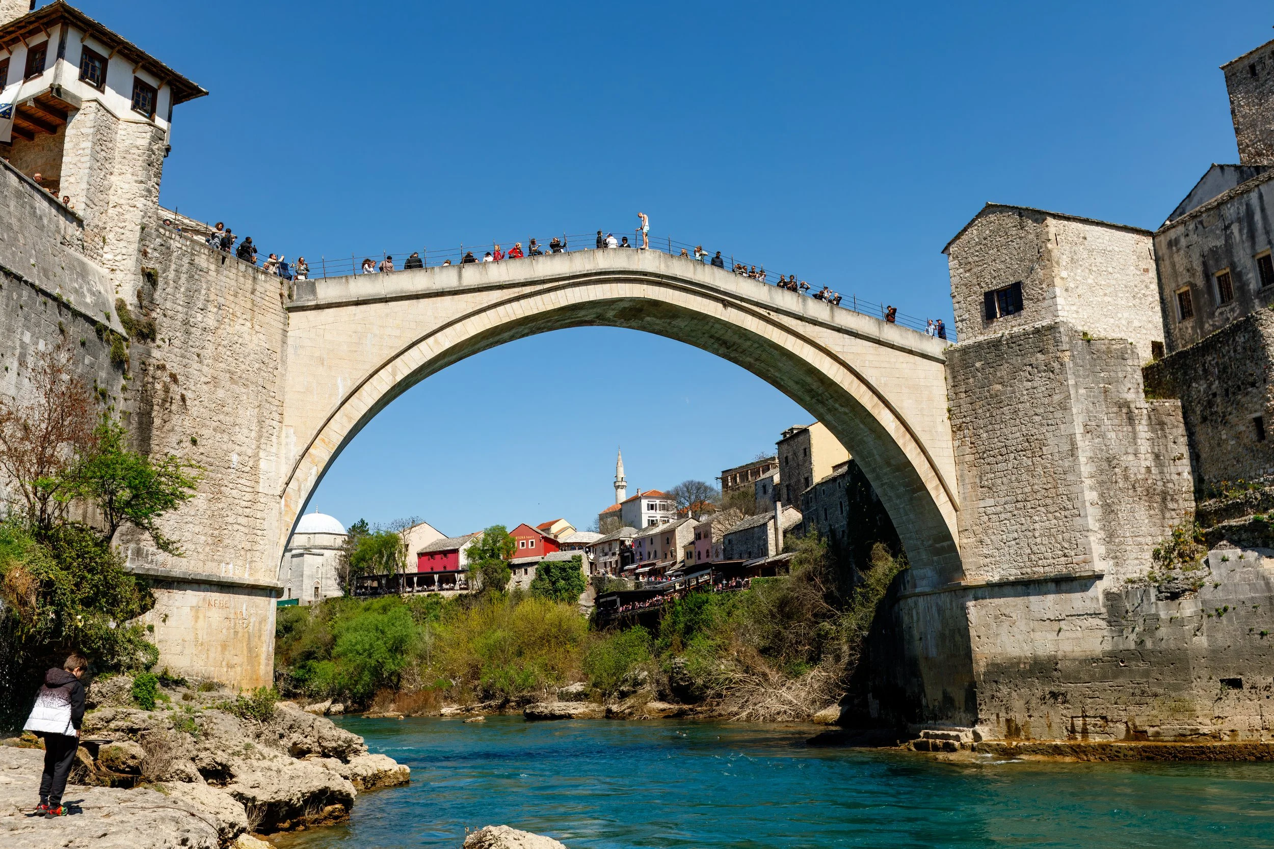  The iconic Stari Most (old bridge) packed with tourists and a “diver” trying to get some attention with intention of a leap into the cold water below 