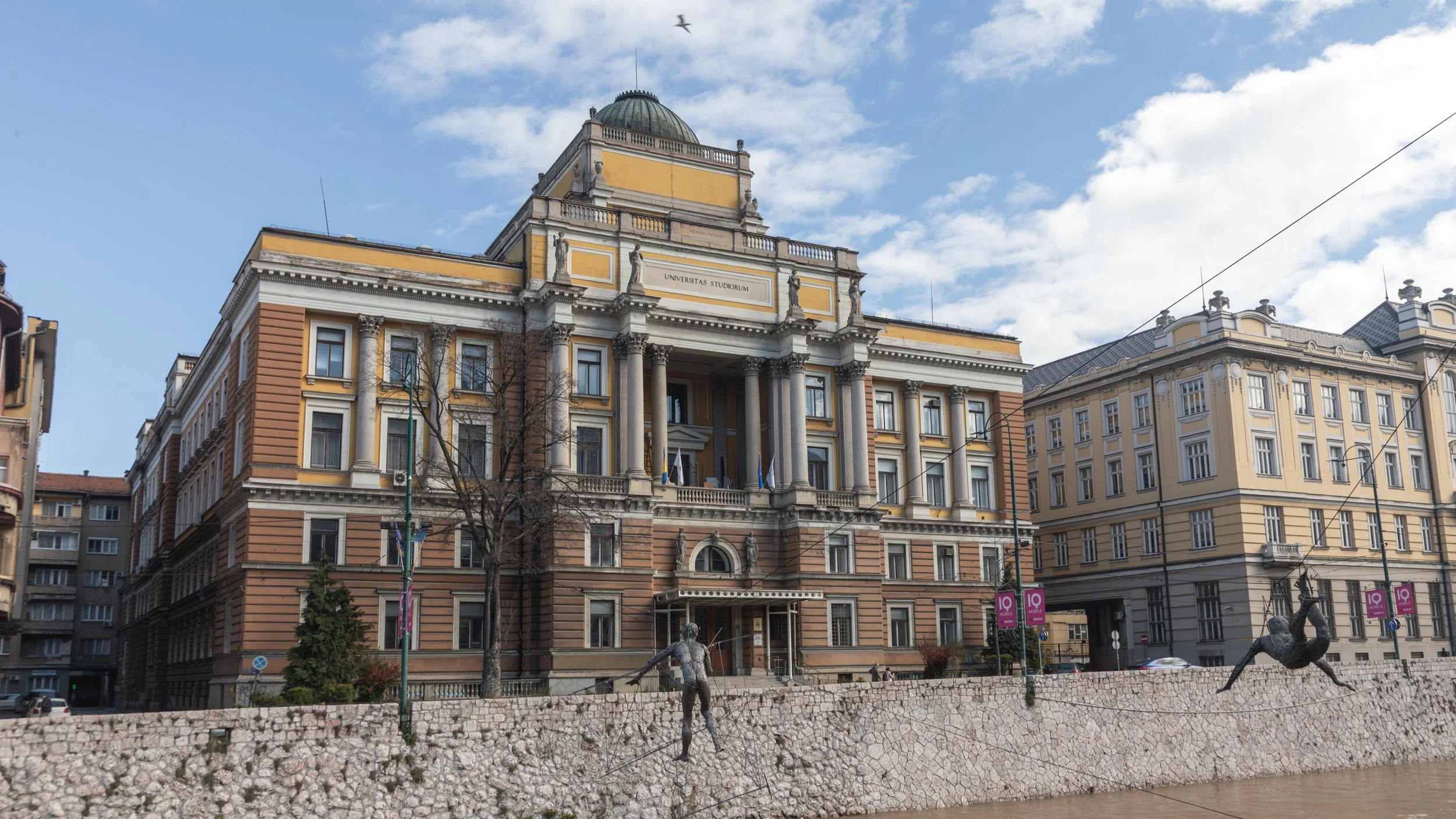  Rectorate of the University of Sarajevo and the Faculty of Law, constructed in the 1850s, with statues hanging over the Miljacka River 