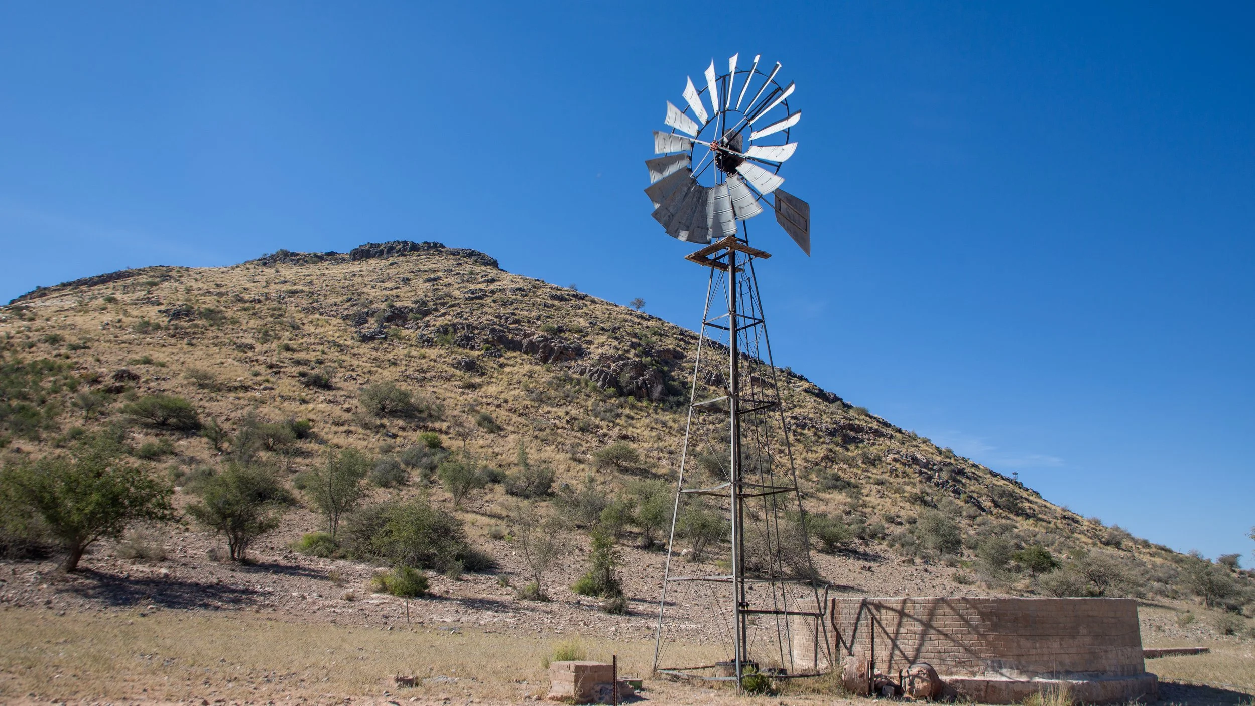  Windmill powers a pump at a watering hole at our lunch picnic stop; unfortunately this pump wasn’t working and the hole had run dry. 