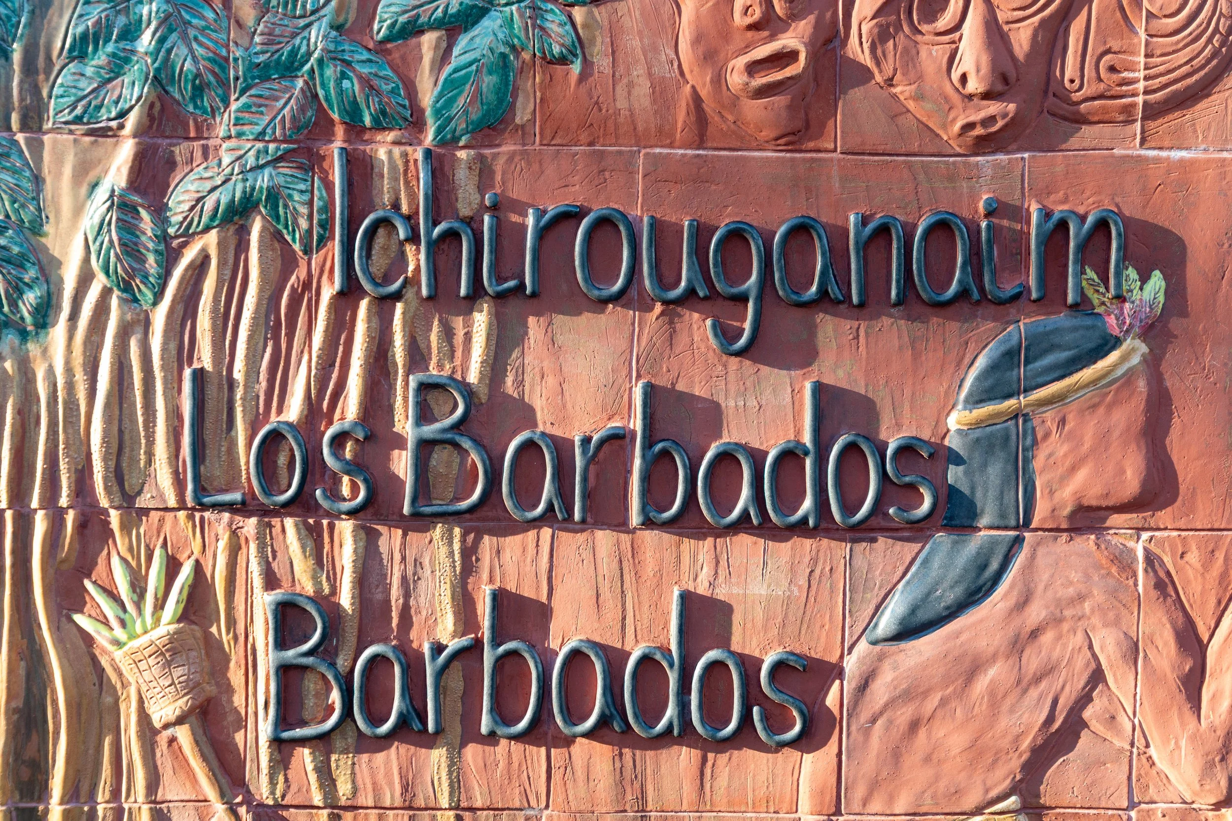  A terracotta and ceramic art relief displaying the historical names of Barbados: Ichirouganaim, Los Barbados, and Barbados 