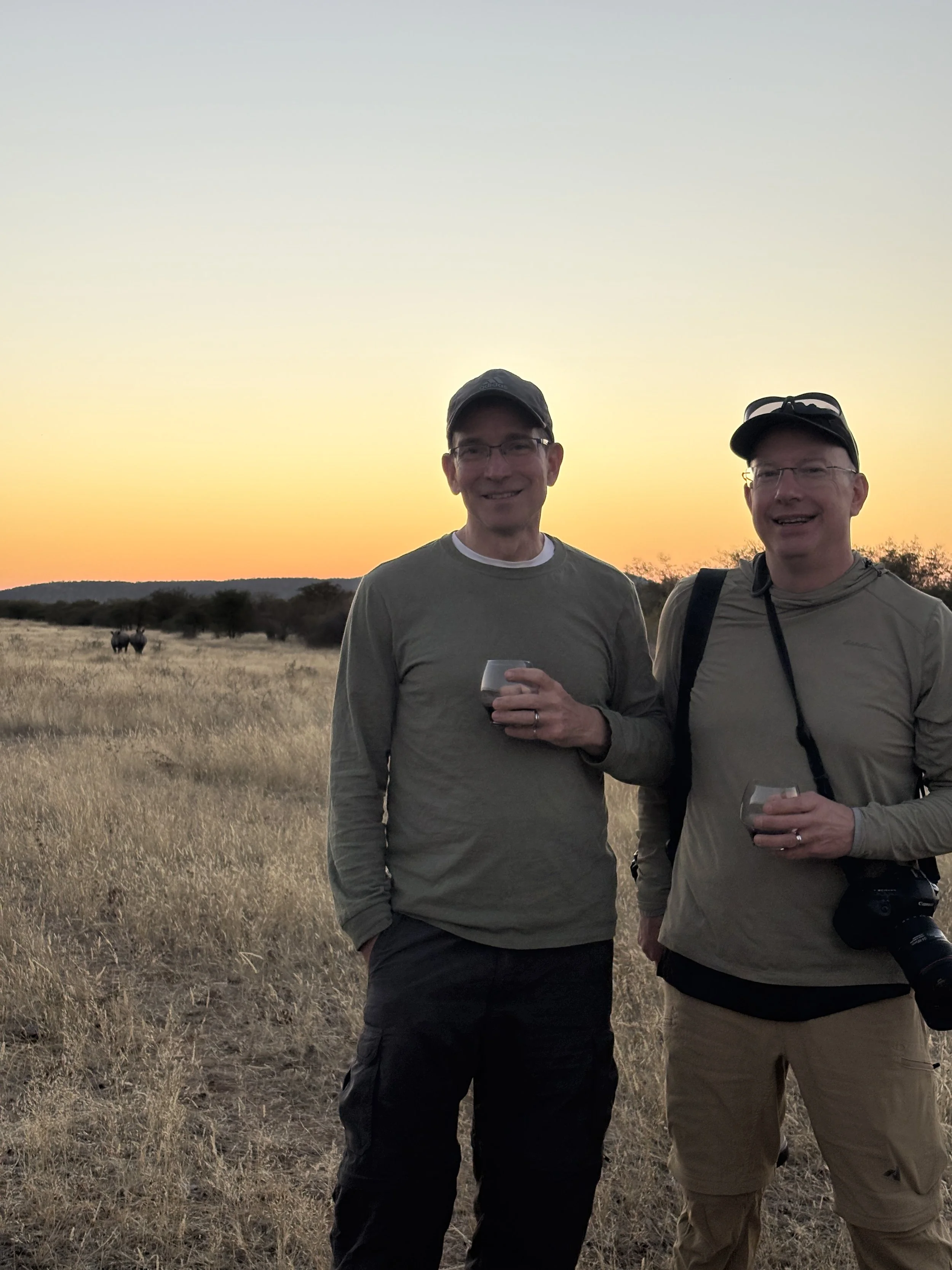  As we enjoy our sundown beverages, two white rhinos approach 