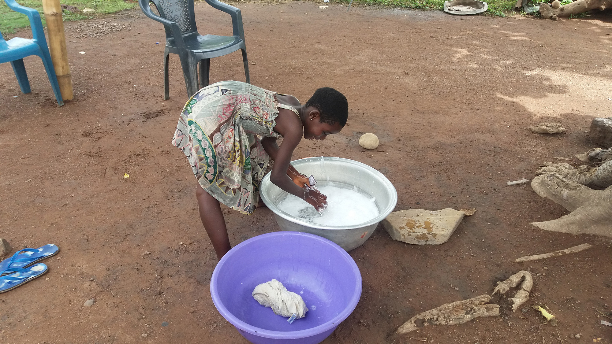 Girls usually help their parents by hand washing clothes during the weekends in sub-Saharan African countries. Electricity and washing machines are extremely rare.