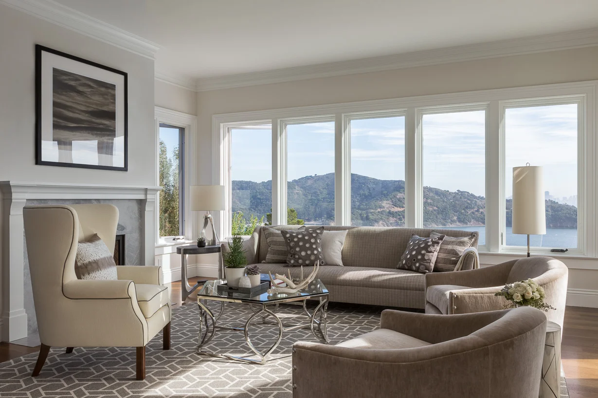 A selection of understated furnishings in neutral hues allows the bay views to remain the focal point in the family room. Throw pillows in Glant and John Robshaw fabrics accent the sofa and leather-trimmed wingback chair. The cocktail table is by Bernhardt.