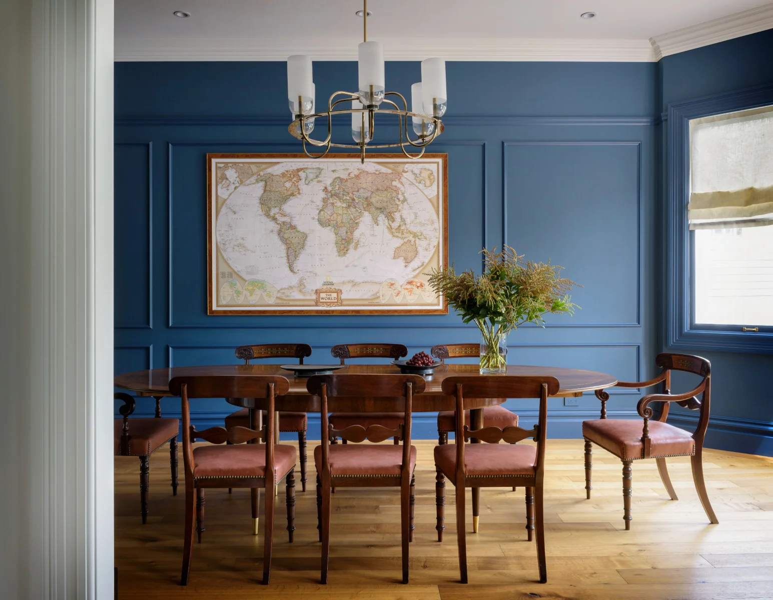 JKA Design selected a rich blue wall color for the dining room of this Cole Valley Victorian. It is the perfect backdrop for the clients' collection of antique maps.